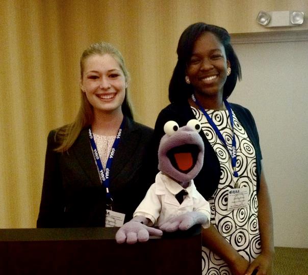 Mississippi State University sophomore Amy Sanford, of Orange Beach, Ala., left, and freshman DeAnna Brown, of Jackson, with puppet mascot "Goddard," are members of the "Space Cowboys" team that won a first-place award at the recent American Institute for Aeronautics and Astronautics regional conference.