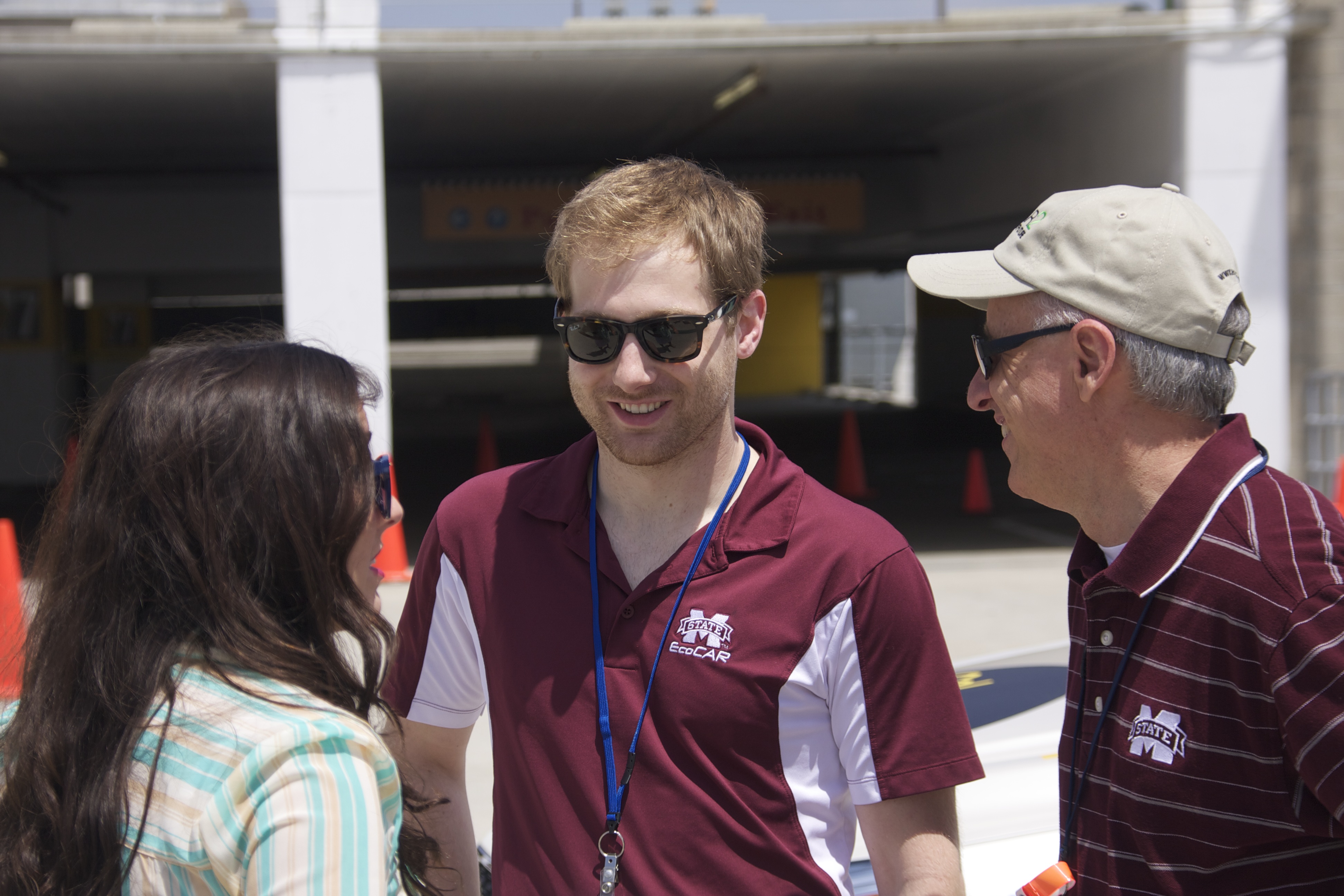 MSU Vice President for Research and Economic Development David Shaw, right, visits with Claire Faccini, communications manager for MSU's EcoCAR 2 team, and Josh Hoop, mechanical group leader, during the EcoCAR 2 competition in San Diego this week.