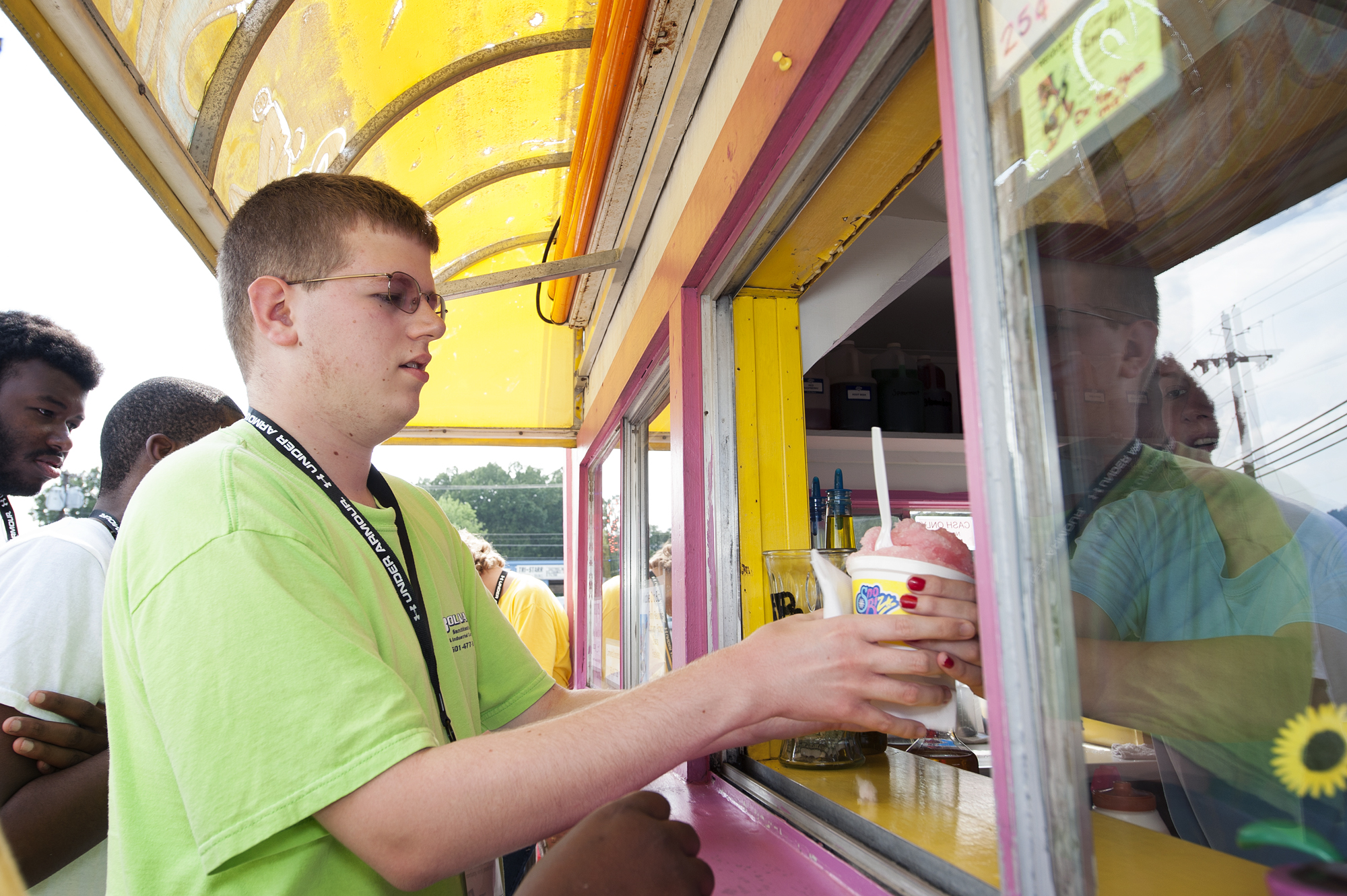 Joshua Smith of Biggersville purchases a snow-cone during Camp Jigsaw activities. Smith, who has an autism spectrum disorder, has participated in the camp at Mississippi State University since it began four years ago. He said while social skills can be difficult, he has learned a lot about controlling behaviors at camp and he has enjoyed the various activities, such as swimming.