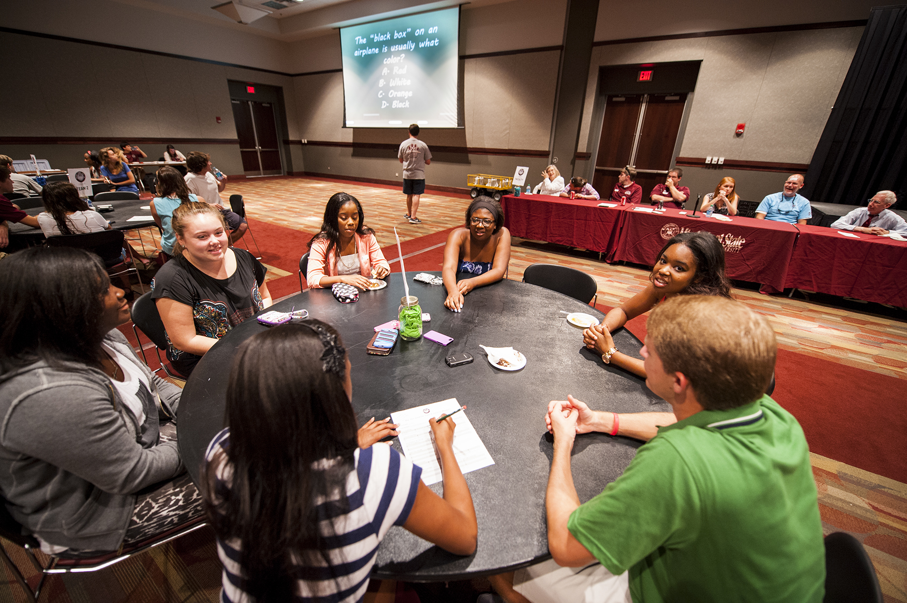 College Ready Program participants at MSU work as a team to answer questions during a trivia night competition against their professors. 