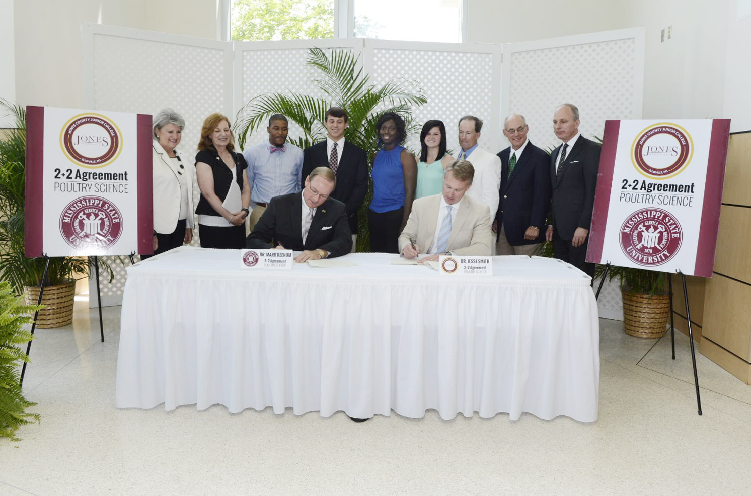 Mississippi State President Mark E. Keenum and Jones County Junior College President Jesse Smith sign an agreement Friday to allow for a smooth transition for JCJC students transferring into MSU's poultry science program. Joining the two presidents were students, faculty and staff from both institutions.