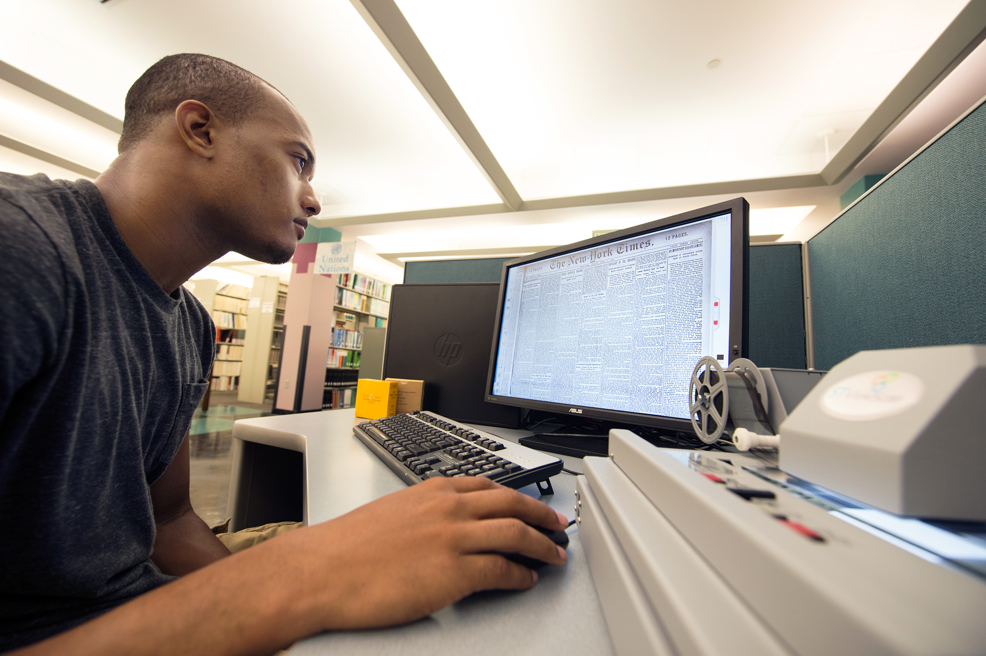 Mississippi State senior De'undre Adams, of Crowder, views microfilm of a June 1894 edition of the New York Times at Mitchell Memorial Library. In addition to students, faculty and staff, the university library offers the general public access to the latest technologies, including this desktop microfilm digital viewer and scanner, searchable by keywords.