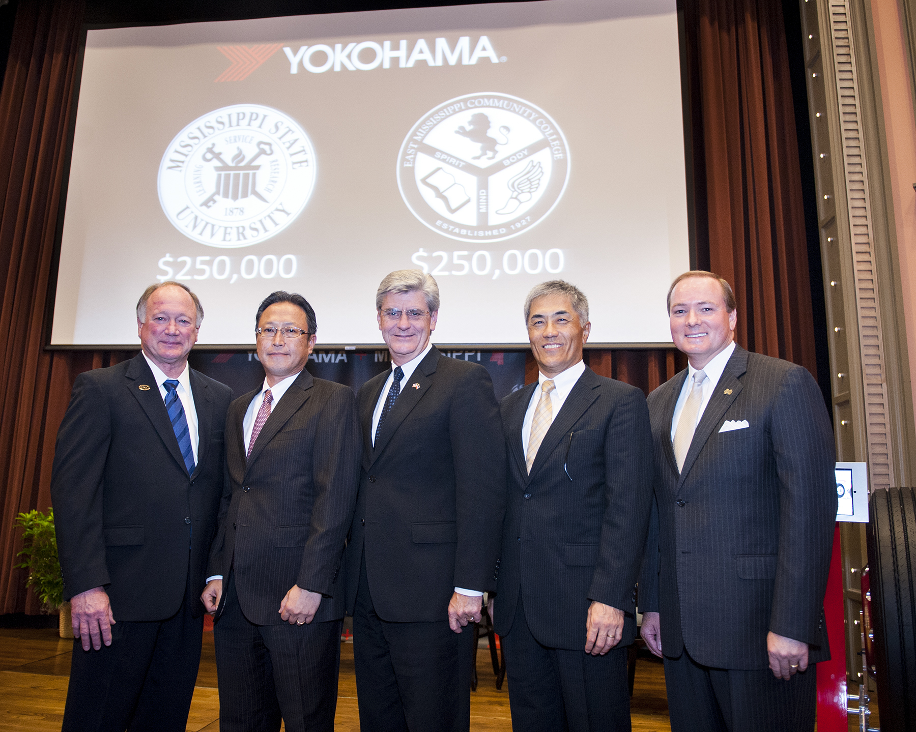 After announcing substantial gifts to Mississippi State and East Mississippi Community College, Yokohama Tire executives posed for an official group photo. Pictured from left, EMCC President Rick Young; President of Yokohama Tire Manufacturing Mississippi Tadaharu Yamamoto; Gov. Phil Bryant; Yokohama CEO Hikomitsu Noji; and MSU President Mark E. Keenum.