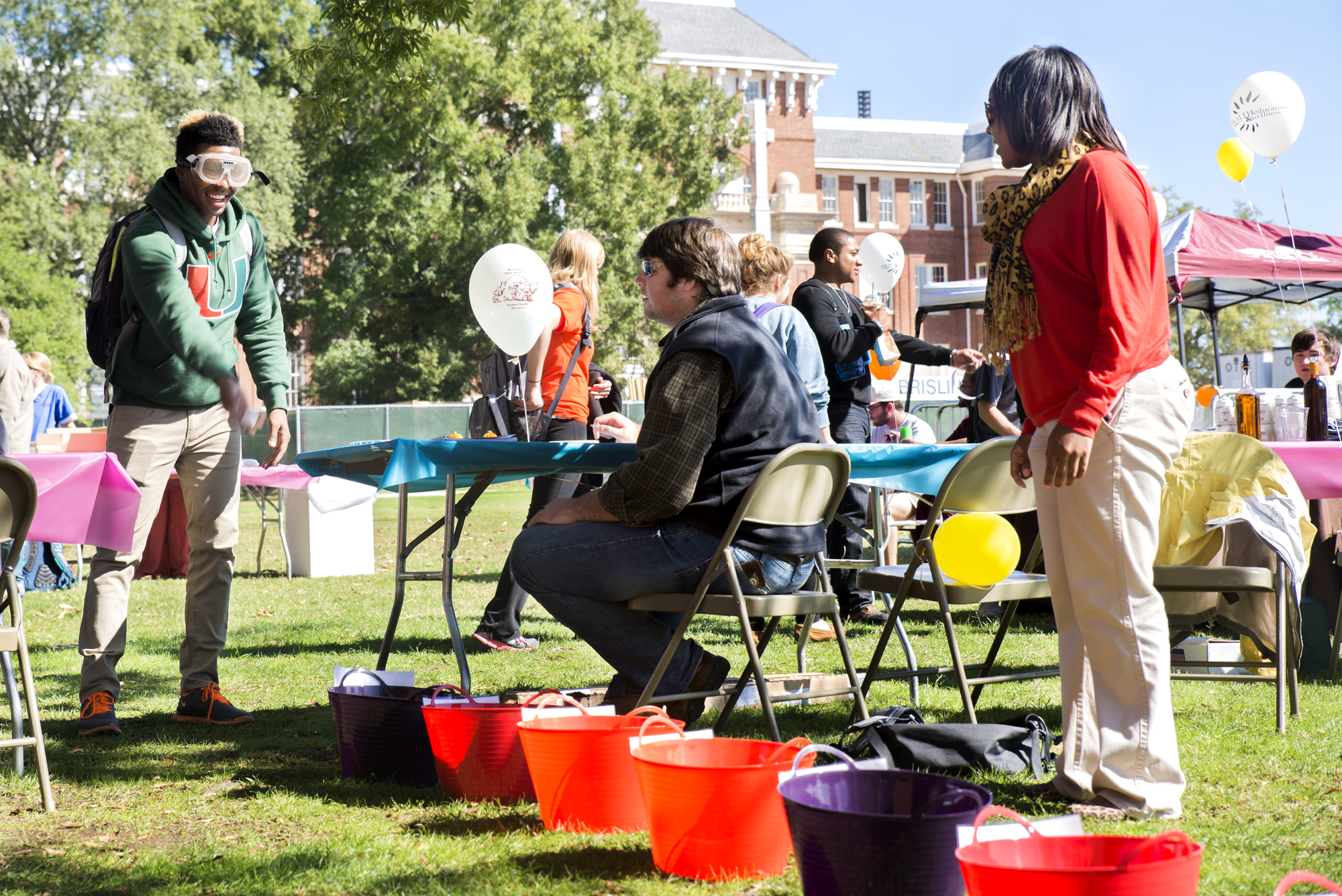 Freshman Jay Newson throws a ball during activities at OkSOBERfest Monday, while freshman Dalton Nutting and graduate student Nelda Bailey look on. The event was designed to promote alcohol safety awareness.