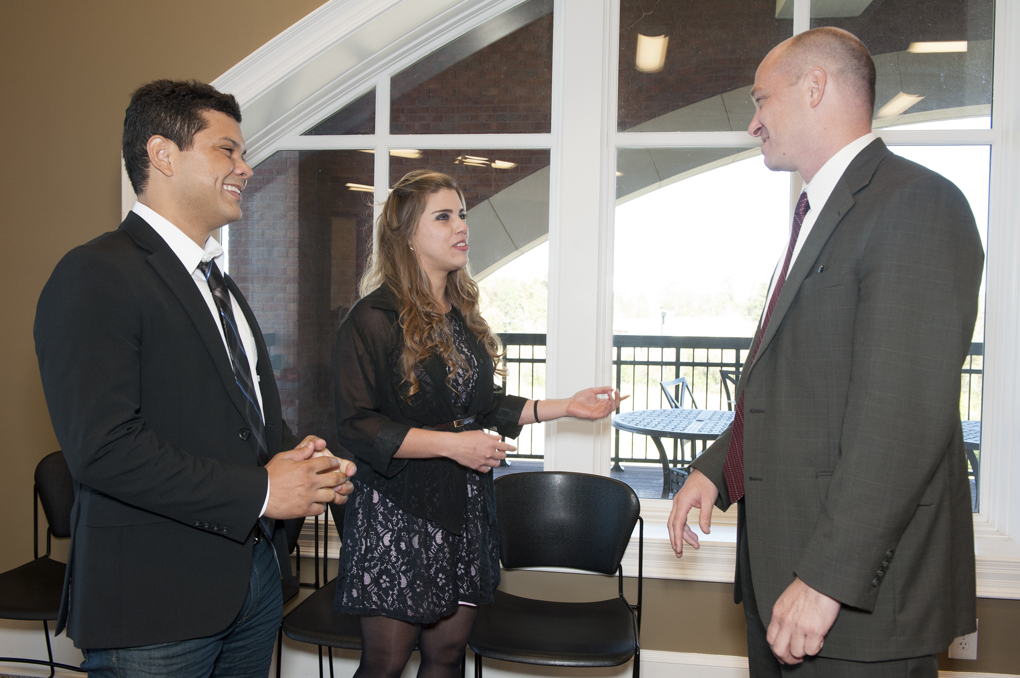 Brazilian exchange students Danilo Gusmao Ferreira Souto (l) and Mariana Bruno De Carvalho Cavalcanti visited with Jon Rezek, interim head of MSU's International Institute, during a campus program celebrating the Brazil Scientific Mobility Undergraduate Program.