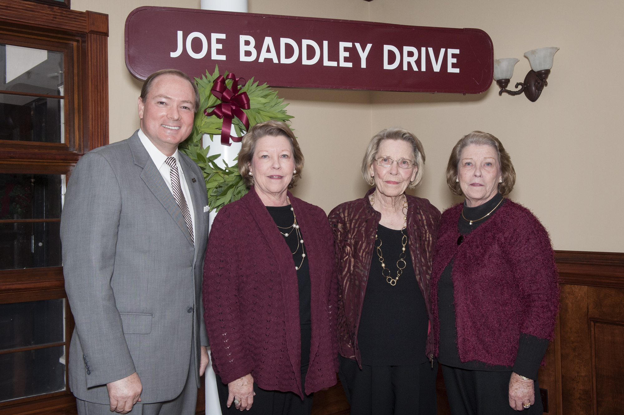 During the Tuesday rededication ceremony at the MSU enology laboratory,<br /><br />
President Mark E. Keenum presented former signage marking Joe Baddley Drive to members of the Baddley family. They include (l-r) Jean Baddley Cox, Connie Baddley, and Joan Baddley Ishee.<br /><br />
