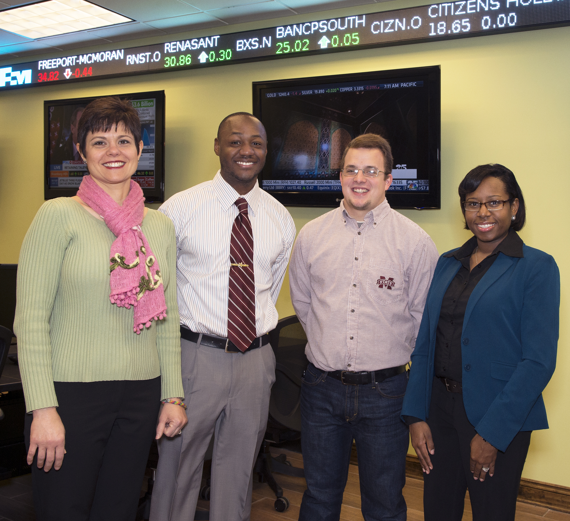 During the fall 2013 semester, Mississippi State teacher technology education students taught The Stock Market Game to members of Starkville's Boys & Girls Club of the Golden Triangle. From left are Becky Smith, MSU agricultural economics assistant extension professor; Lucas Davenport, Boys & Girls Club director; Douglas "Cole" Bostick, TTE senior; and Pamela Scott-Bracey, TTE assistant professor.