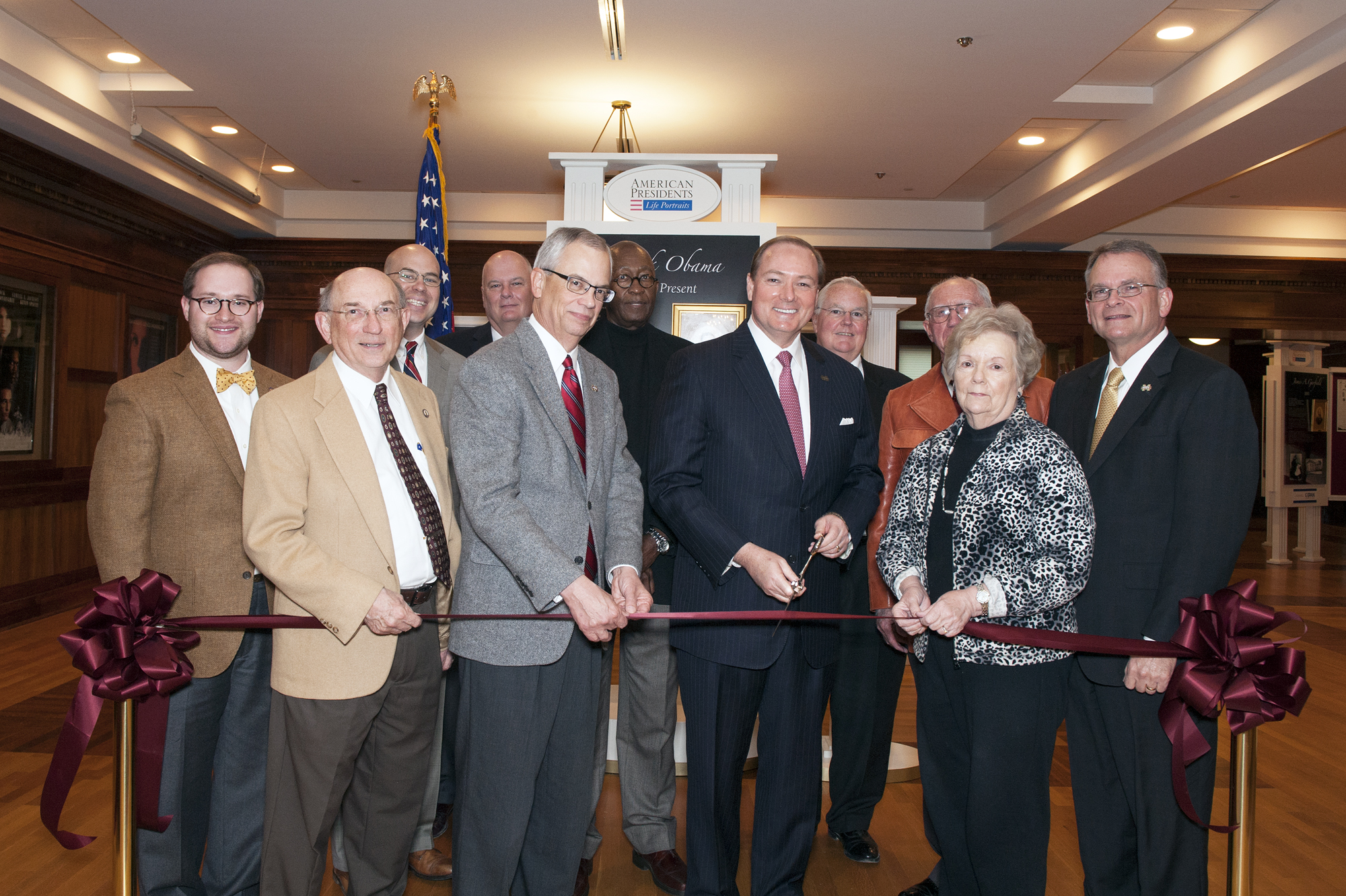 At a ribbon cutting ceremony for "American Presidents: Life Portraits" were, front (l-r) John Marszalek, executive director of the Ulysses S. Grant Presidential Library; MSU Provost and Executive Vice President Jerry Gilbert; MSU President Mark E. Keenum; Dean of Libraries Frances Coleman; and Vice President of Student Affairs Bill Kibler; back (l-r) Kyle Jordan, field representative for Rep. Gregg Harper; Starkville Mayor Parker Wiseman; Eddie French, interim director of the Stennis Institute of Government and Community Development; K.C. Morrison, head of MSU's political science and public administration department; Rex Buffington, executive director for the Stennis Center for Public Service Leadership; and Hank Mosley, special assistant for constituent services for Rep. Gregg Harper. 