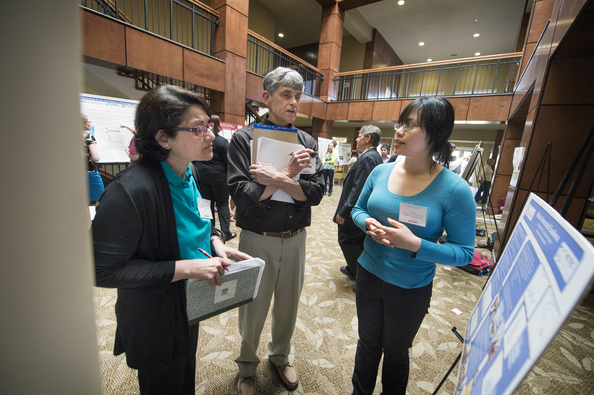 Lucy N. Ly of Biloxi (right) is among 14 Mississippi State students honored recently the university's 2014 Undergraduate Research Symposium. A senior industrial engineering major, she discusses her project with associate professor Rani Sullivan and professor Keith Koenig, two of the symposium's judges.