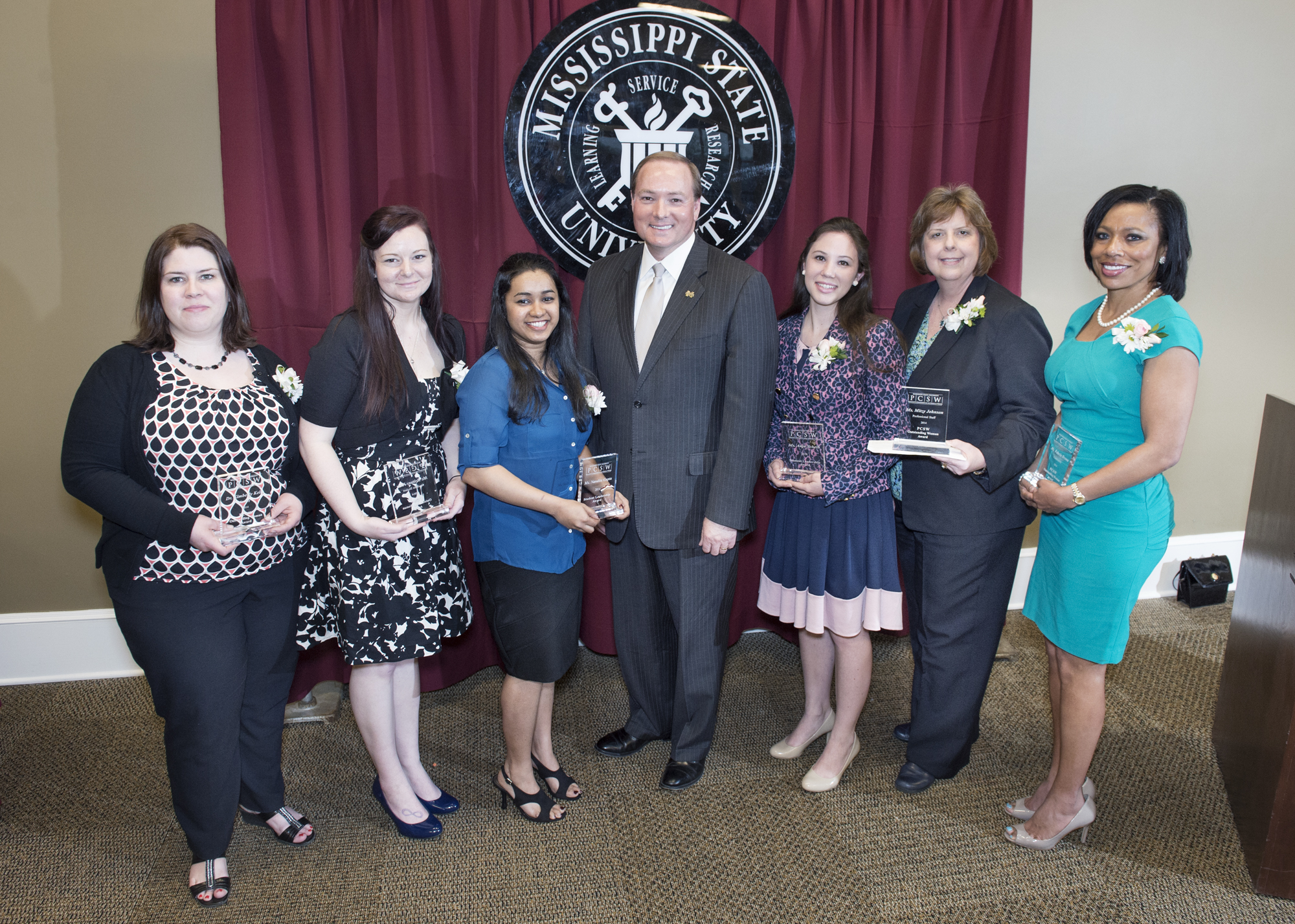 Receiving honors this year from the MSU President's Commission on the Status of Women are (from left) Kimberly Kelly, Brittany Perez, Nandita Gupta, Anja Scheib, Mitzy Johnson, and Felecia Brown. Extending congratulations is President Mark E. Keenum, keynote speaker at the campus awards ceremony.