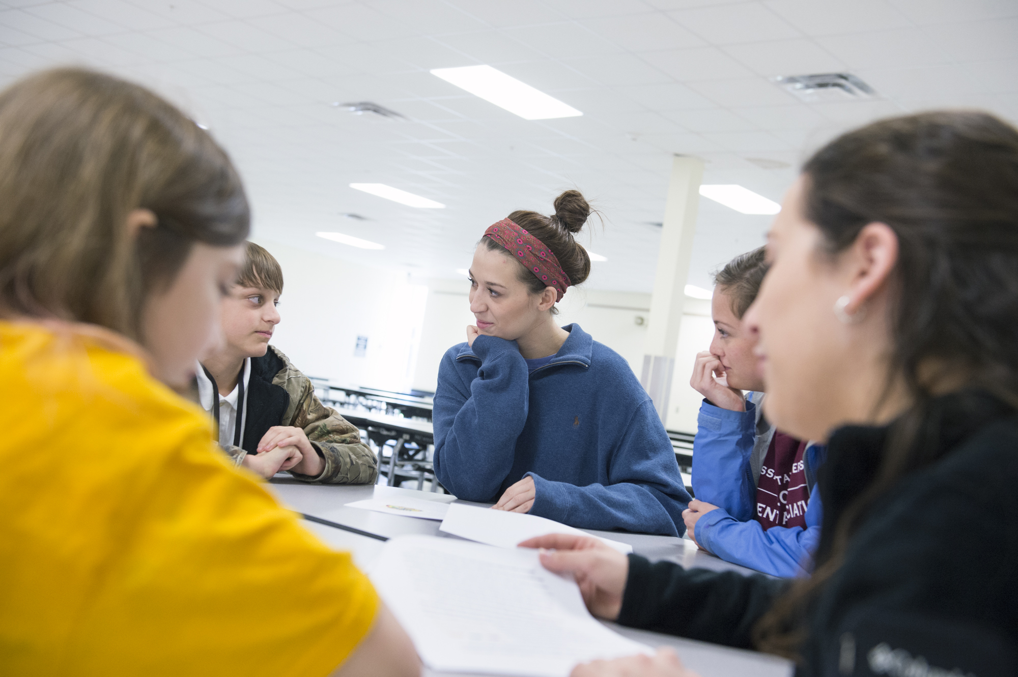 Mississippi State University senior Elizabeth A. Anderson, center, listens to an Armstrong Middles School student's feedback about how kindness can stop bullying. Future middle school teachers recently joined sixth-graders to plan seeds of kindness, part of the A-OK anti-bullying initiative.