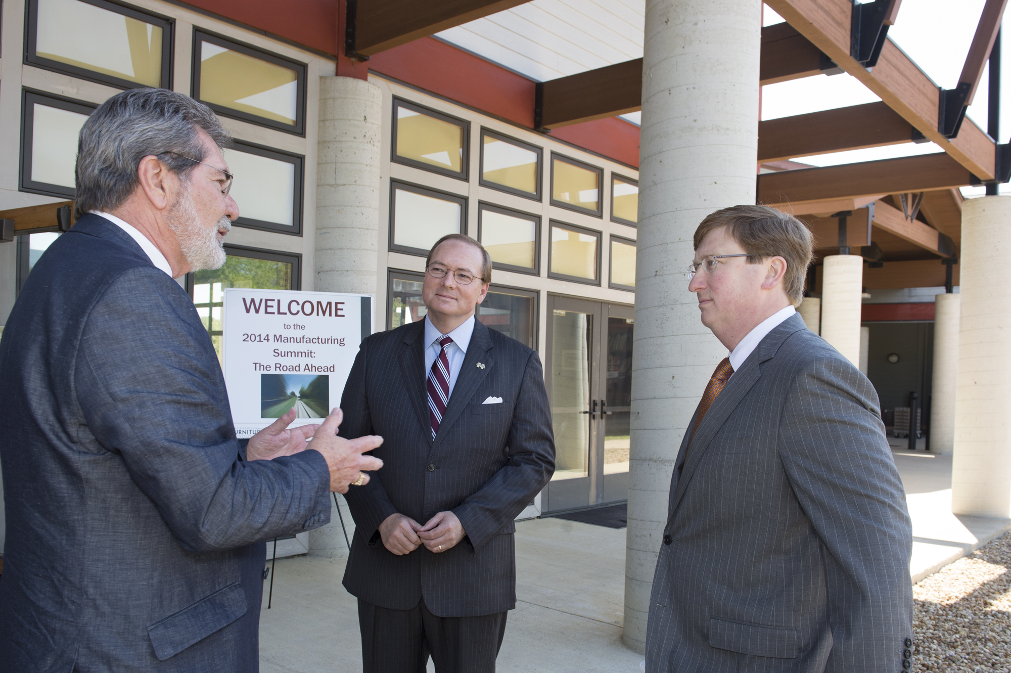 Mississippi State University's annual Furniture Summit hosted Mississippi Lt. Gov. Tate Reeves, right, as keynote speaker. Franklin Furniture Institute Director Bill Martin, left, discusses furniture manufacturing initiatives with MSU President Mark E. Keenum and Reeves.