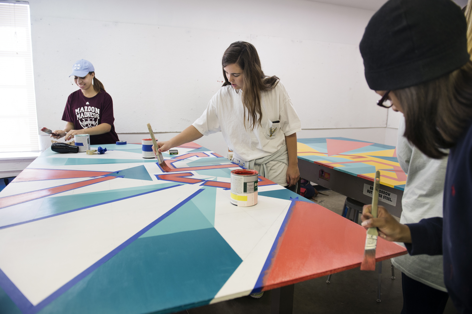 During the just-concluded spring semester, a group of MSU students were part of a service-learning art project to design and paint an eight-foot-square wooden barn quilt. Among group members were (l-r) Brooke Rankins, Katy Coleman and Sydney Armer.  