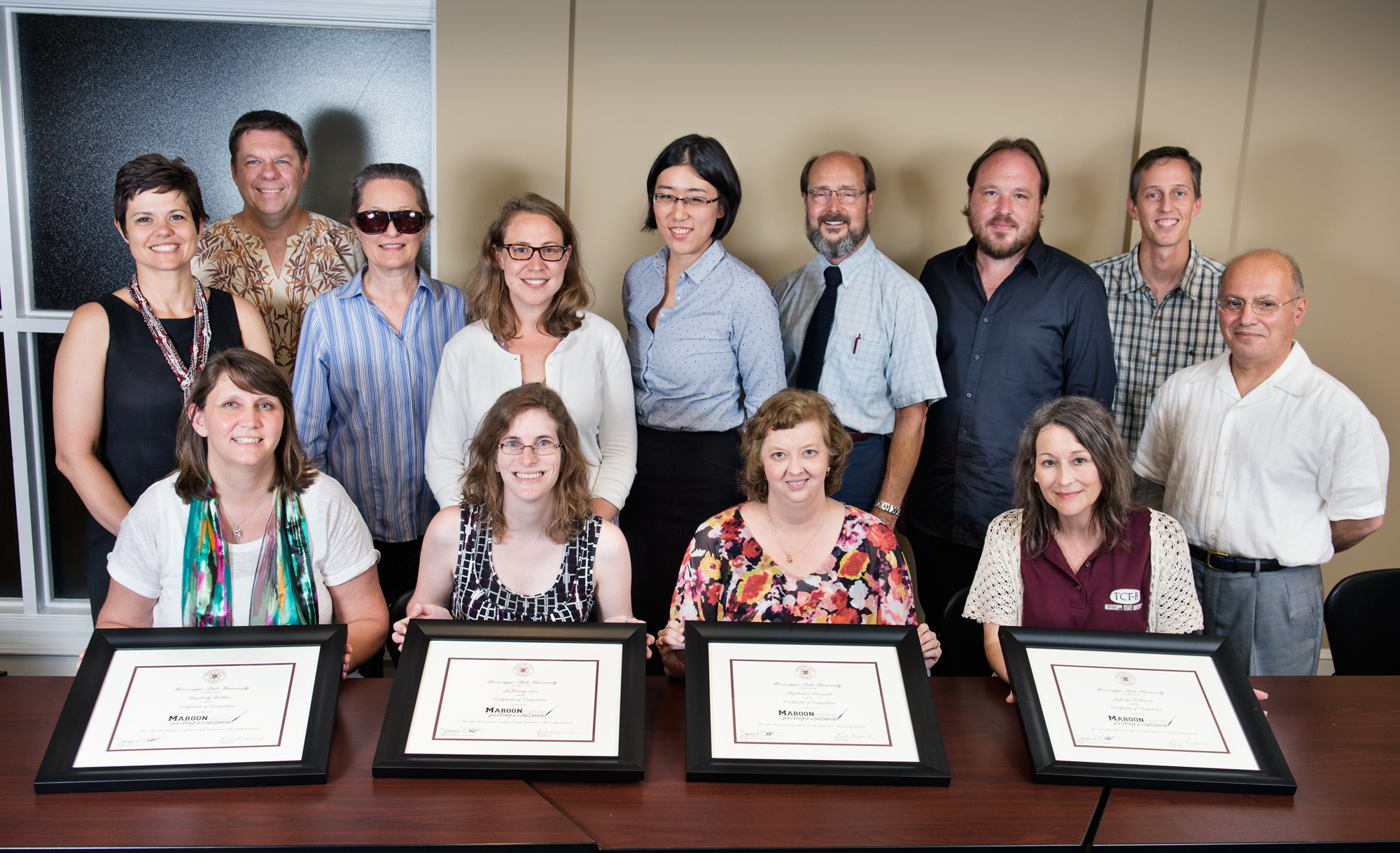 New Maroon Institute for Writing Excellence graduates include (seated from left) Kim Walters, Stephanie Bennett, Amy Crumpton and Renee Clary, (standing from left) Becky Smith, Robert Damm, Elizabeth Payne, Melanie Loehing, Juyoung Lee, institute facilitator Rich Raymond, Jeff Roberson, Peter Allen and Mehrzad Netadj.