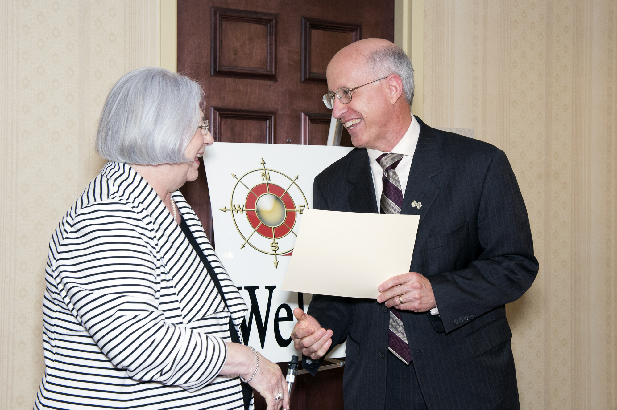 Nellah Taylor, chair of the SOAR board of directors, recently presented a certificate announcing a $10,000 grant for Mississippi State's new rural education research center and learning laboratory. David Shaw, vice president for research and economic development, accepted the award on behalf of the university.	