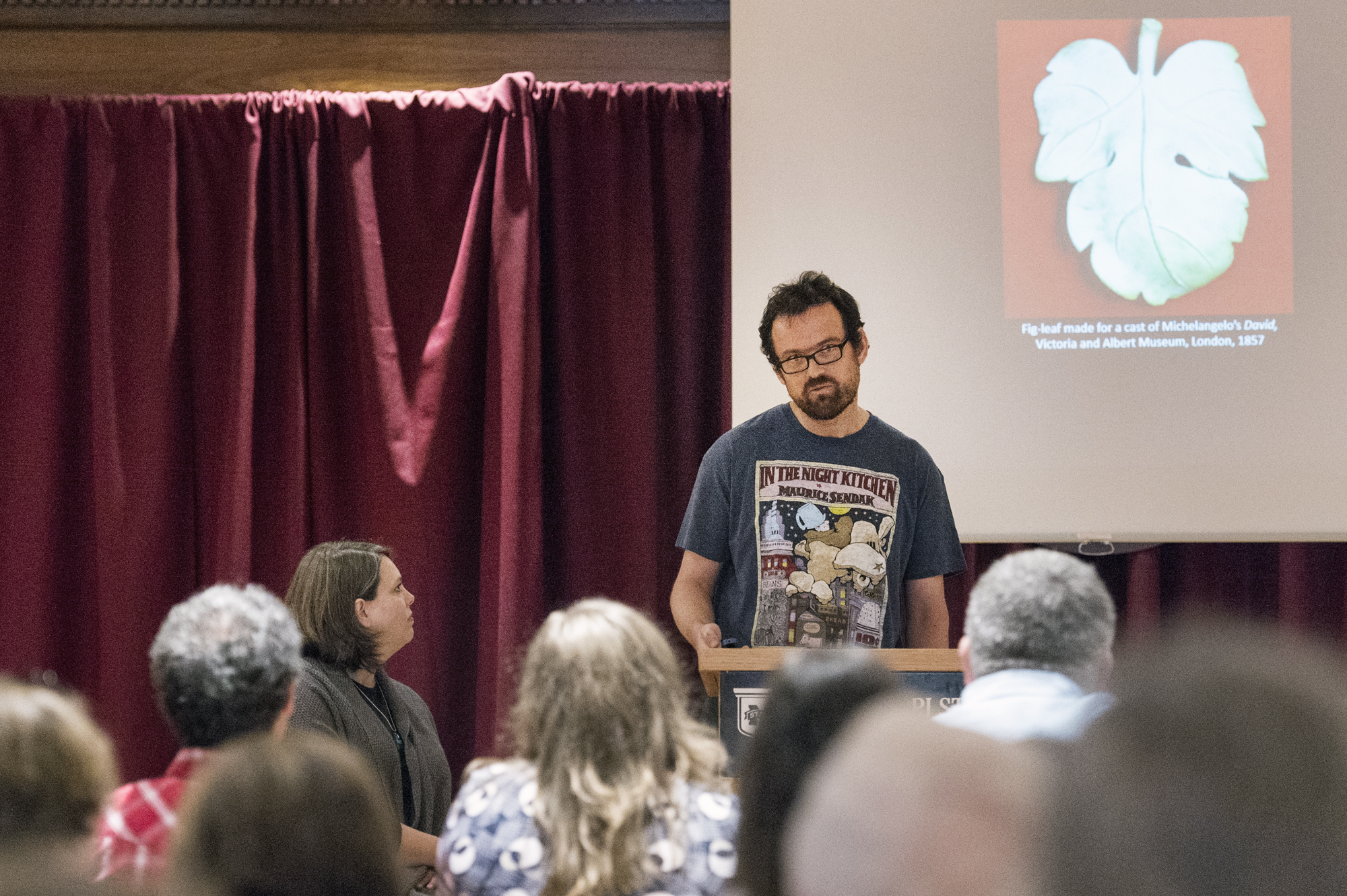 Ben Harvey, associate professor of art, read Maurice Sendak's "In the Night Kitchen" at Mississippi State University's Banned Books Week Read-Out. The children's book has been censored for its portrayal of nudity, and Harvey explained how covering up nudity, such as with a fig leaf, may draw more attention to it.