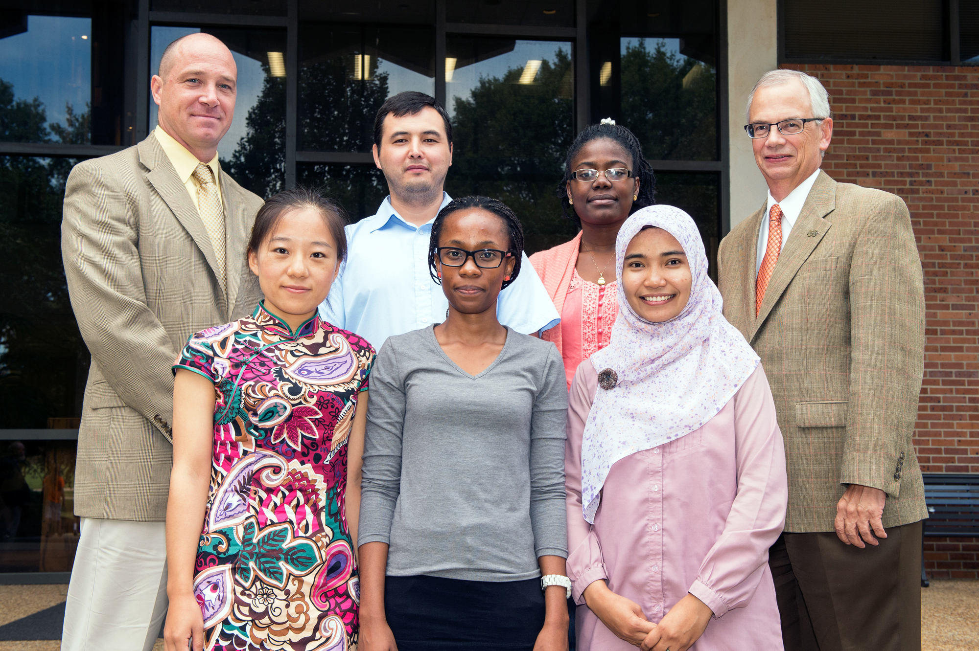 Pictured with Interim Associate Vice President and Executive Director of MSU's International Institute Jon Rezek, back left, and Provost and Executive Vice President Jerry Gilbert, back right, are (front, l-r) new Foreign Language Teaching Assistant Liu Chang of China, Phumla Mawisa of Namibia, and Nur Azizah of Indonesia; (back, l-r) Nurdin Tuiachiev of Kyrgyzstan, and Lauriane Yehouenou of Benin.