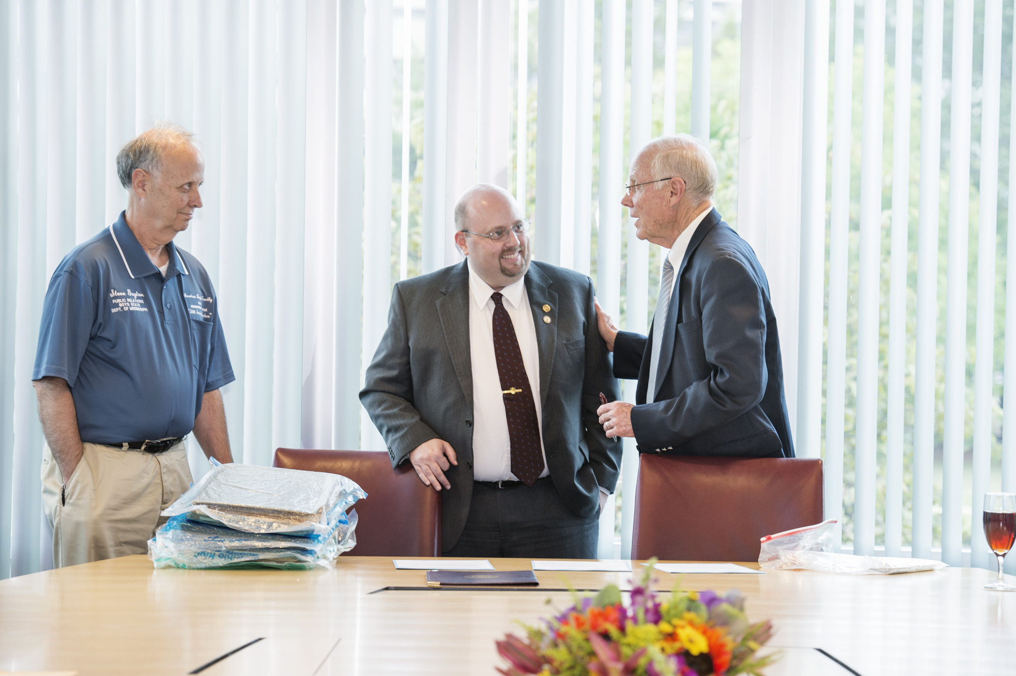 During a special campus ceremony Wednesday, brothers Steve and Sam Guyton (left and right, respectively) presented a collection of scrapbooks developed by their late sibling, Earl Love Guyton, to Ryan Semmes of the MSU Libraries.