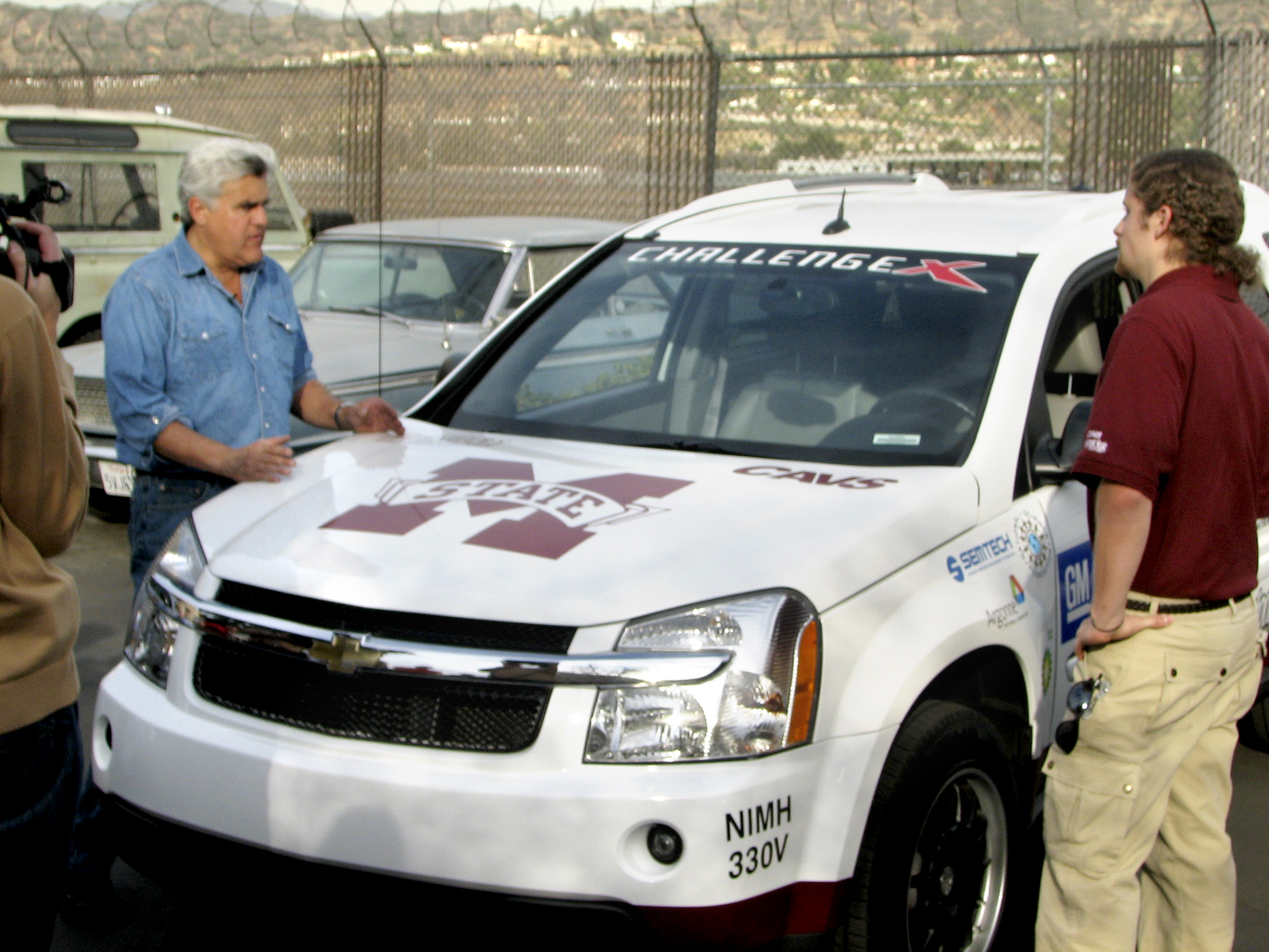 Comedian Jay Leno (l) and MSU student Stephen Phillips discuss the winning Challenge X vehicle.  Phillips is an electrical engineering graduate student from French Camp.