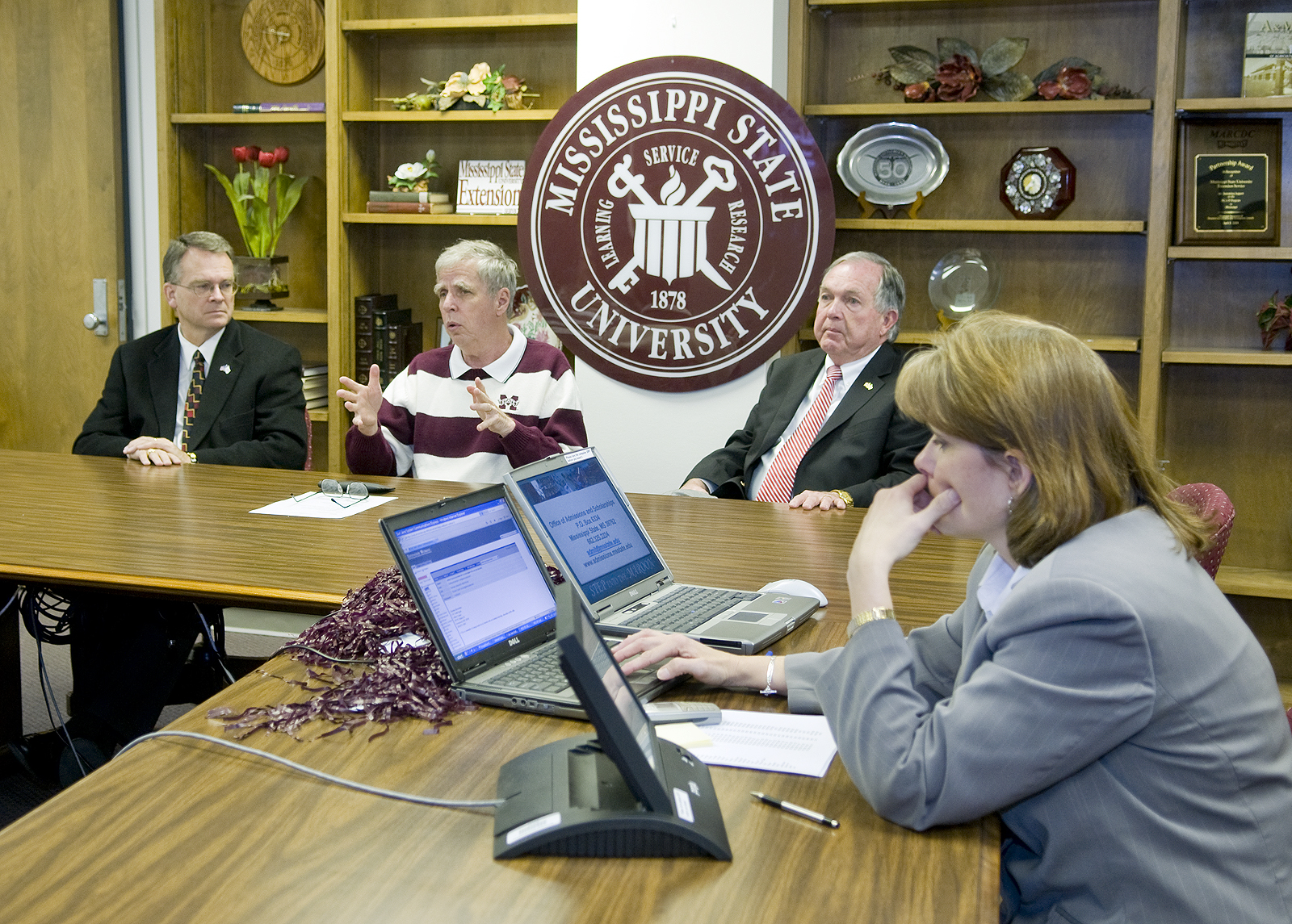 President Robert Foglesong (second from left) answers a question in last week's videoconference link that helped MSU celebrate its 130th birthday.  Also pictured are (from left) vice presidents Bill Kibler and Vance Watson, and MSU Extension Service computer applications specialist Susan Seal.