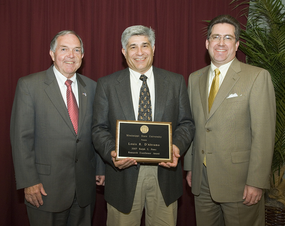 Powe Award winner Louis D'Abramo (c) is congratulated by vice president Vance Watson (l) and interim vice president Kirk Schulz.