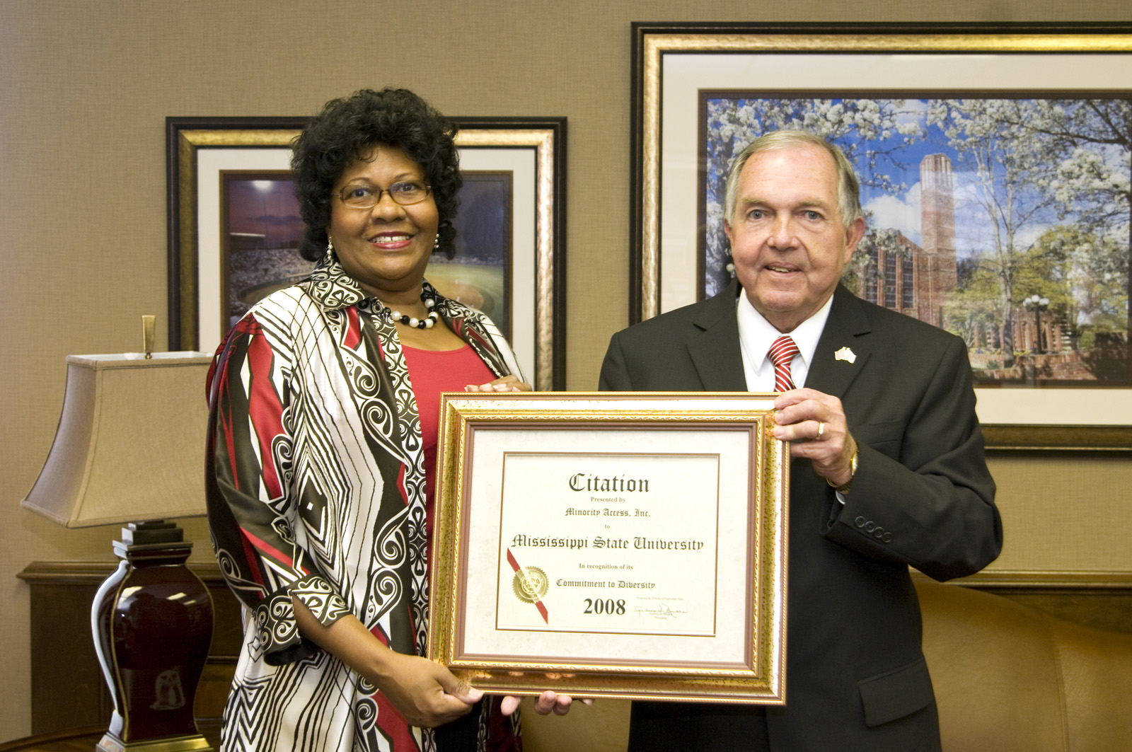 MSU administrator Mary Alexander presents Minority Access Inc. award to Interim President Vance Watson.