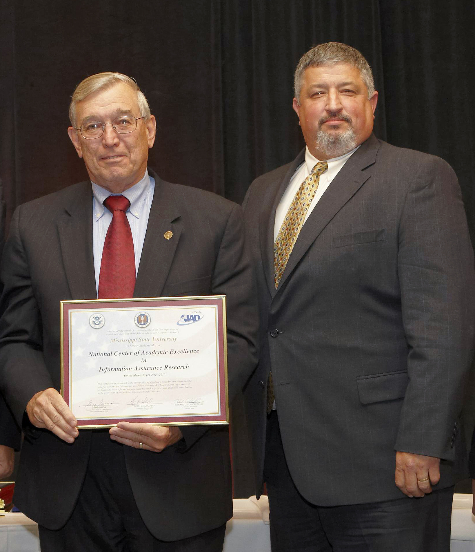 Ray Vaughn (l) and David Dampier display MSU's newest NSA certification.