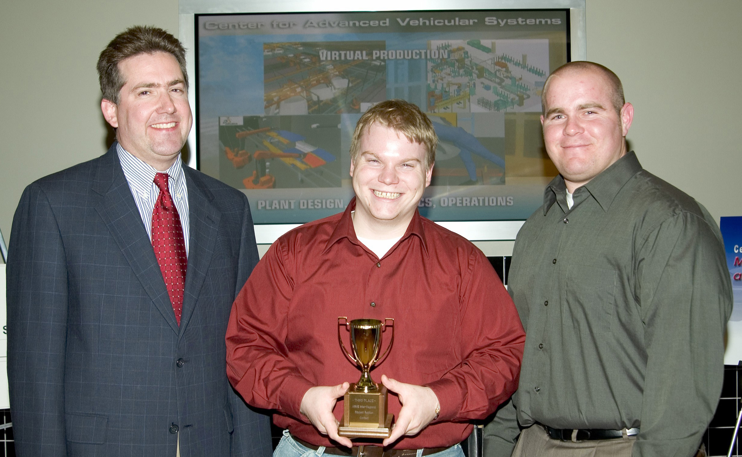 Justin M. Crapps of Florence, Ala., c, and Joseph Matthew "Matt" Jones, r, of Clinton, both senior mechanical engineering majors at Mississippi State, display an award just presented by Kirk Schulz, dean of the Bagley College of Engineering. MSU's student section of the American Society of Mechanical Engineering was a third-place finisher in national competition sponsored by the organization. Jones is the current ASME section president, while Crapps is the immediate past president and current coordinator of the student group's Ingersoll-Rand Inter-regional awards competition.