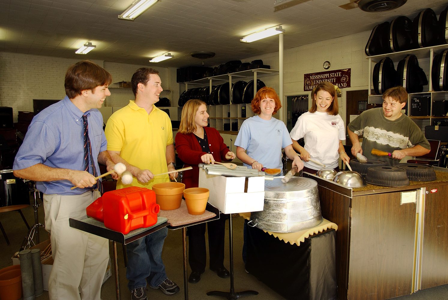 <br /><br />
Bob Damm of music education (left) leads members of the university's Percussion Ensemble rehearsing with a variety of unusual instruments.