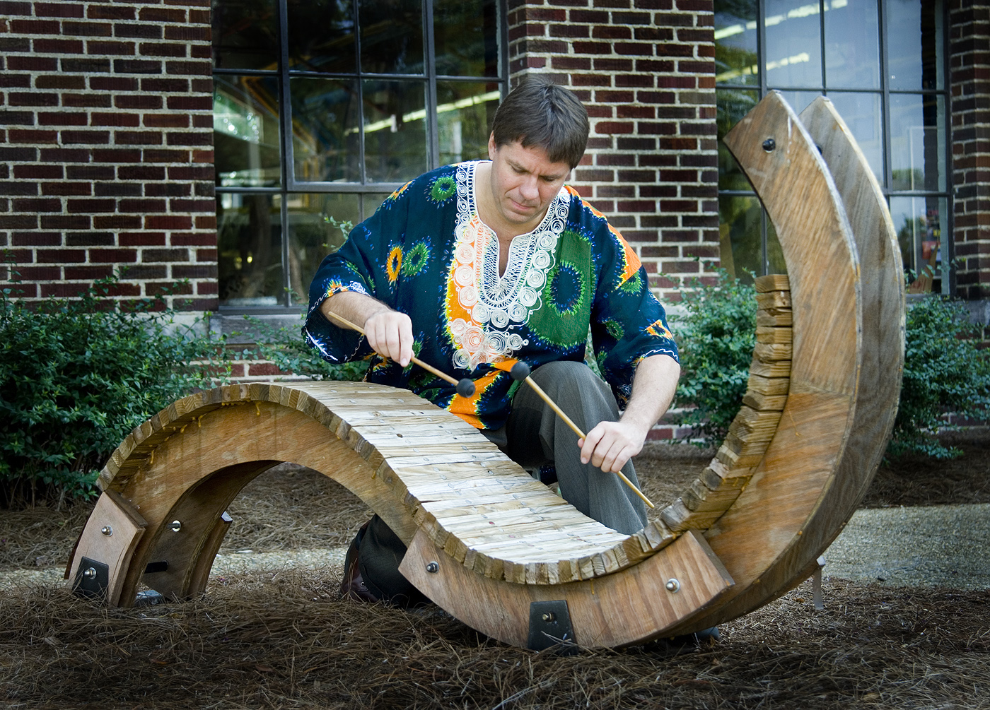 MSU percussionist Robert Damm pretends to play a sculpted version of a marimba.