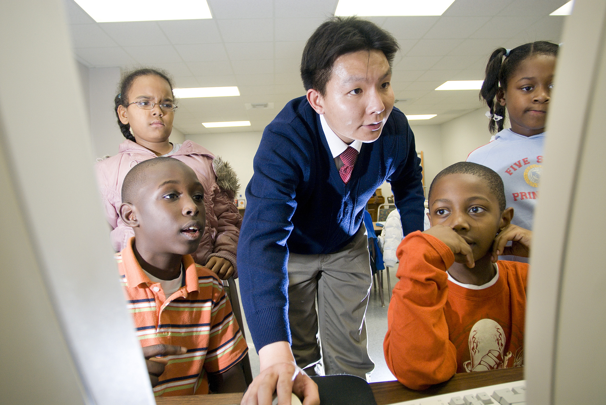 John Ye of Mississippi State University's Bagley College of Engineering shows a computer program to members of the Boys and Girls Club of Oktibbeha/ Starkville, (l-r), Jamal Williams, Faith Martin, Aundrilyn Evans, and Jermaine Clark.