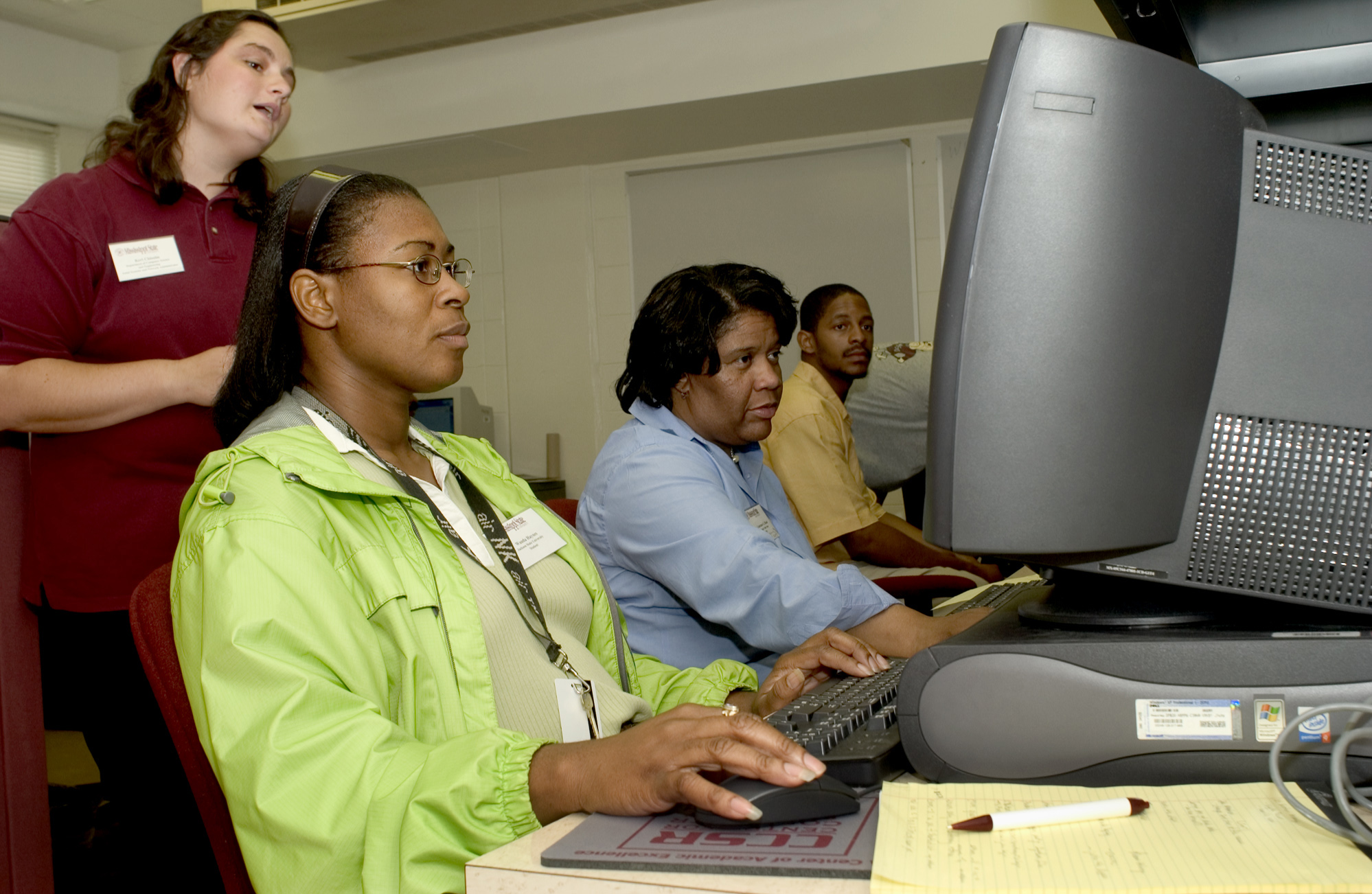 <br /><br />
Keri Chisolm (standing), assistant systems and network administrator for Mississippi State's Center for Computer Security Research, provides guidance to workshop participants (l-r) recent Jackson State University graduate Wanda Haynes and Mississippi Valley State computer science professor Constance G. Bland. They were learning how to take a "byte" out of crime during MSU's June 23-24 Information Assurance Workshop.<br /><br />
 