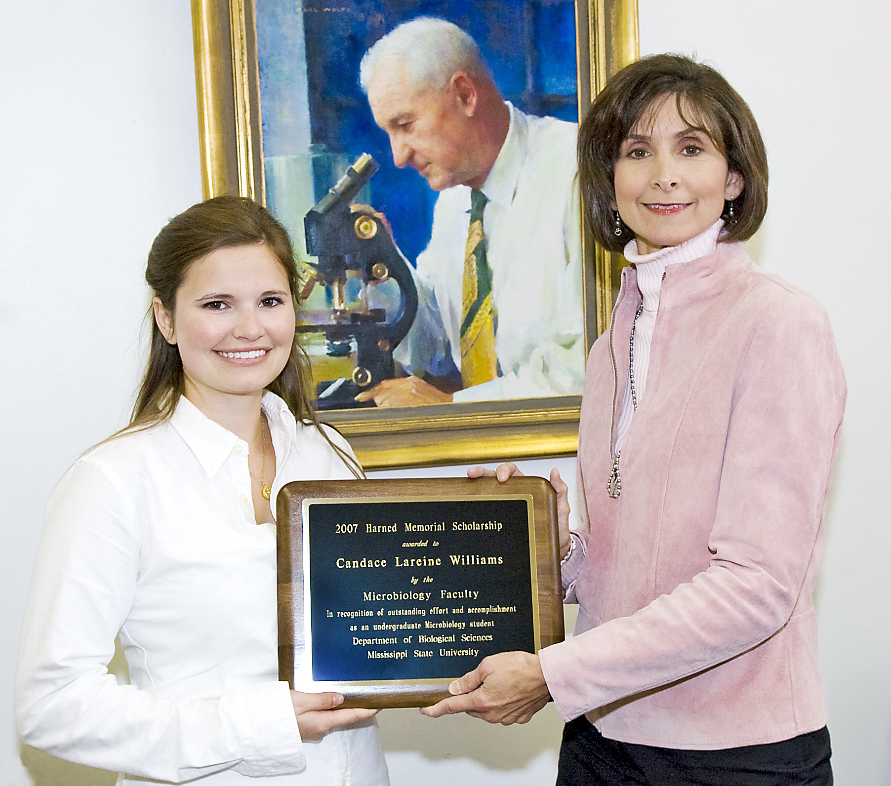 Williams (l) and Coats before a portrait of H.H. Harned Sr.