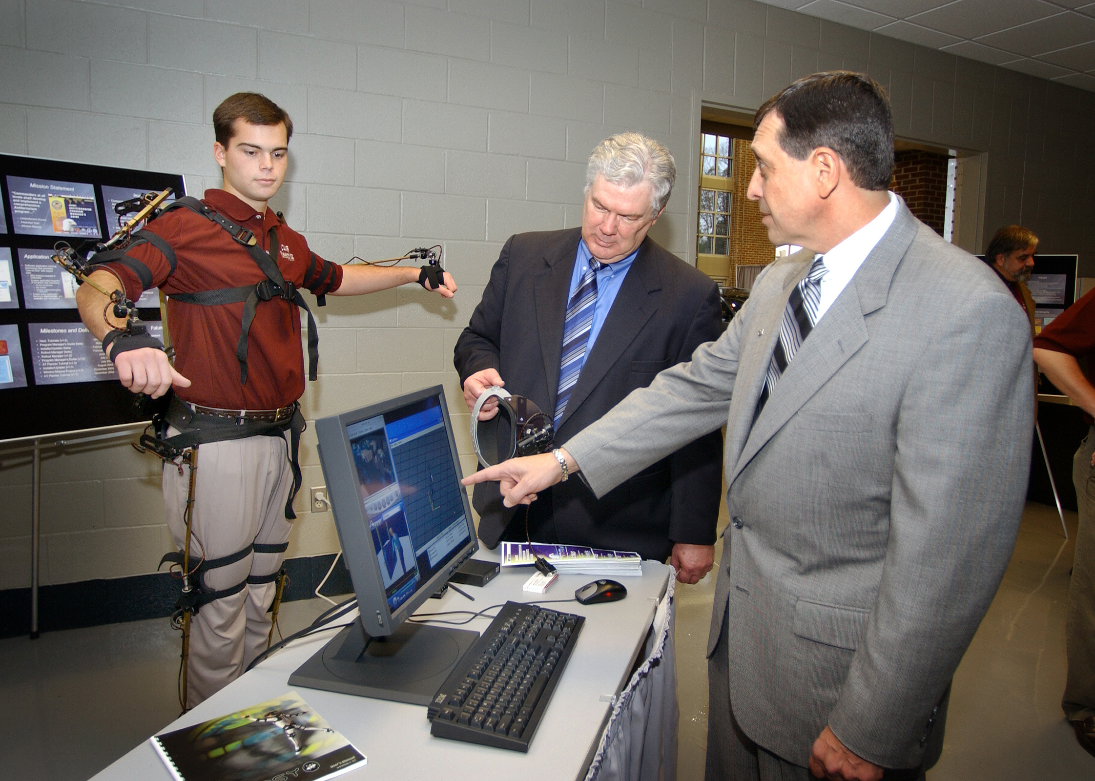 <br /><br />
Mechanical engineering freshman Brandon Witbeck (l) of Starkville demonstrated a motion capture suit Thursday during opening ceremonies for Mississippi State University's Center for Advanced Vehicular Systems.  Looking on at the new Starkville facility were J. Donald Trotter (c), CAVS interim director, and John P. Calandro, Nissan director of human relations and administration.<br /><br />
 