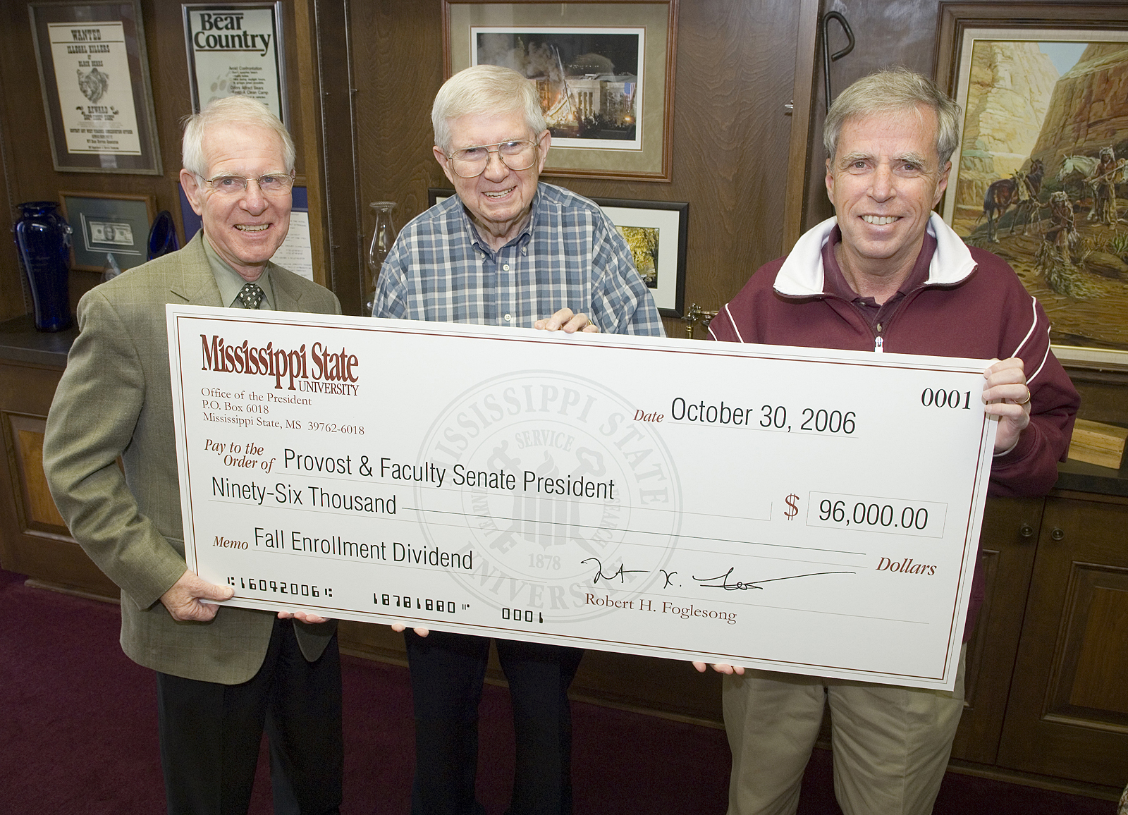 MSU Provost Peter Rabideau (l) and Faculty Senate President Robert Wolverton accept "dividend" check from President Robert Foglesong.