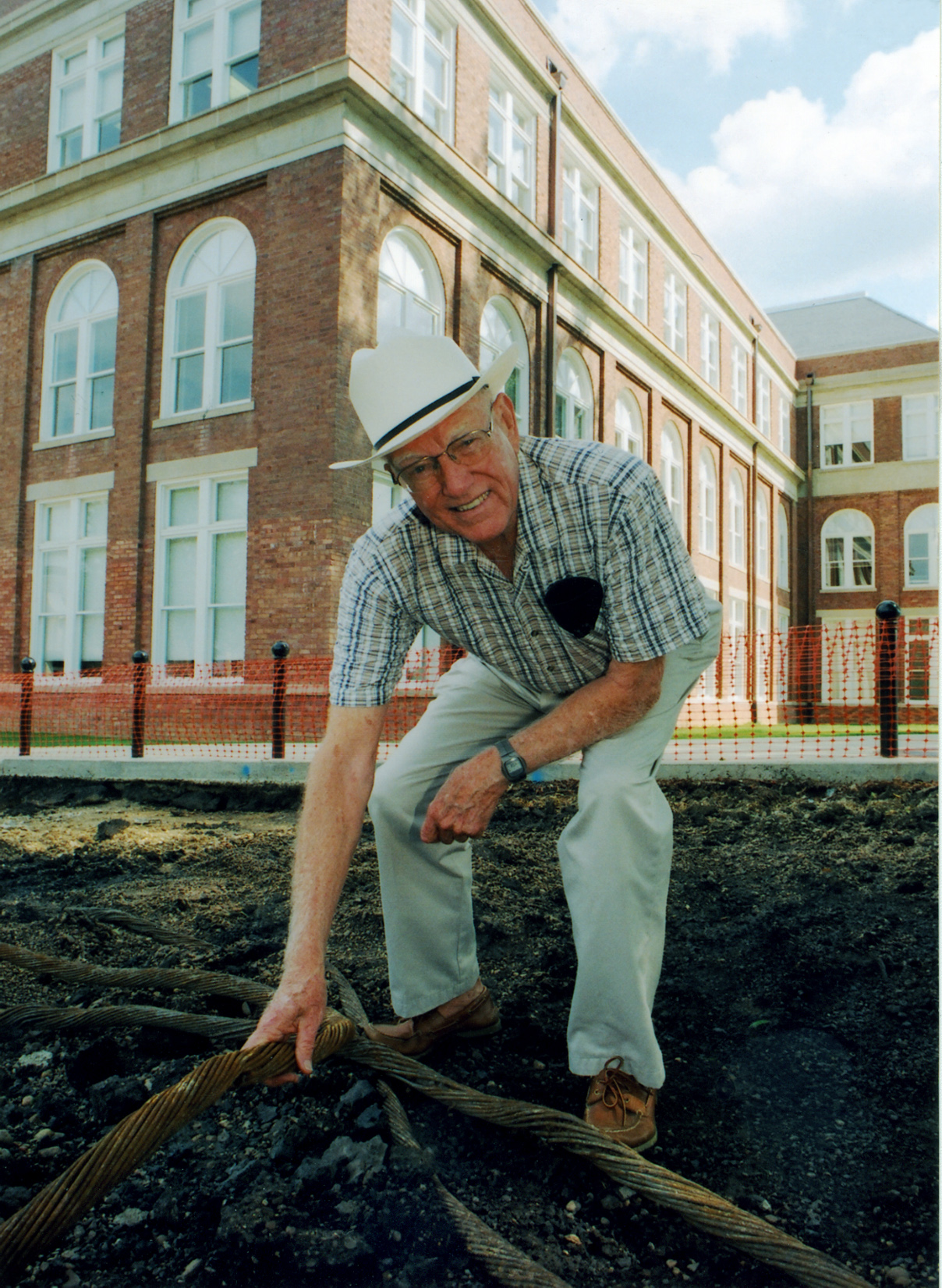 <br /><br />
Retired MSU administrator Chester McKee displays a section of the once-buried cable. 