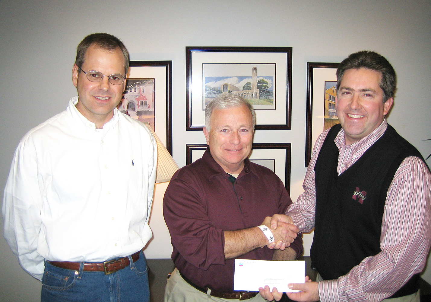 Steve Renfroe, center, public and government affairs manager for Chevron Corp.'s Pascagoula refinery, recently presented a $60,000 check to Kirk Schulz, right, dean of MSU's Bagley College of Engineering, for a variety of departments and programs within the college. Also on hand for the presentation was Blake Hudson, left, development director for the college.