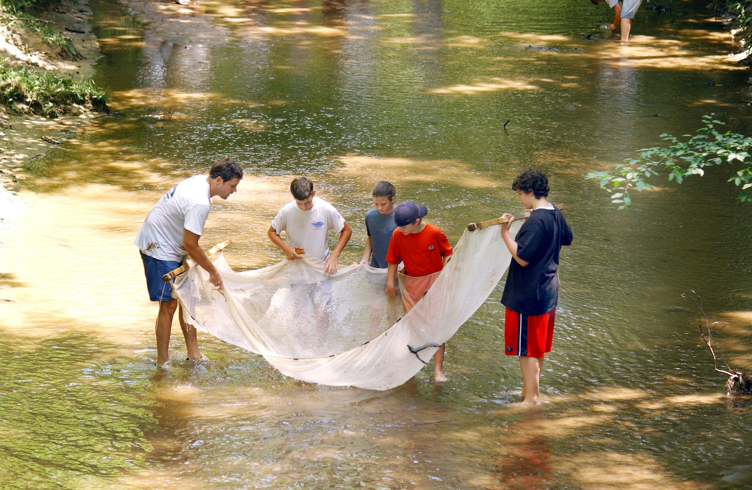 <br /><br />
MSU biological scientist Chris Taylor discusses stream ecology with CREST students (second from left to right) Alex Rowe, Kate Henson, Reed Chandler, and David Hatcher. 