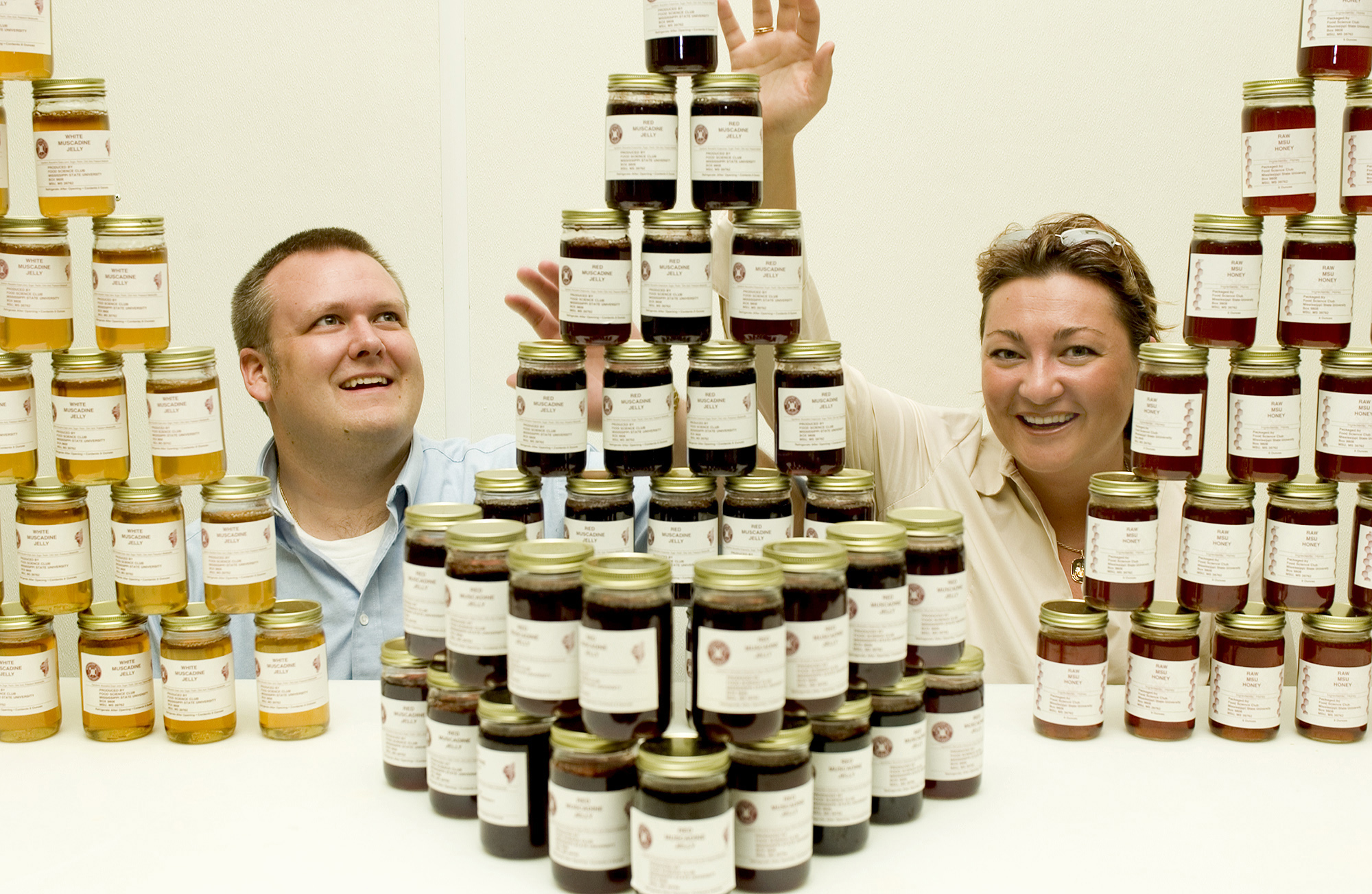 <br /><br />
MSU Food Science Club officers Neil Bogart and Jelena Stojanovic with some of the jellies, jams and honey members produce annually.  