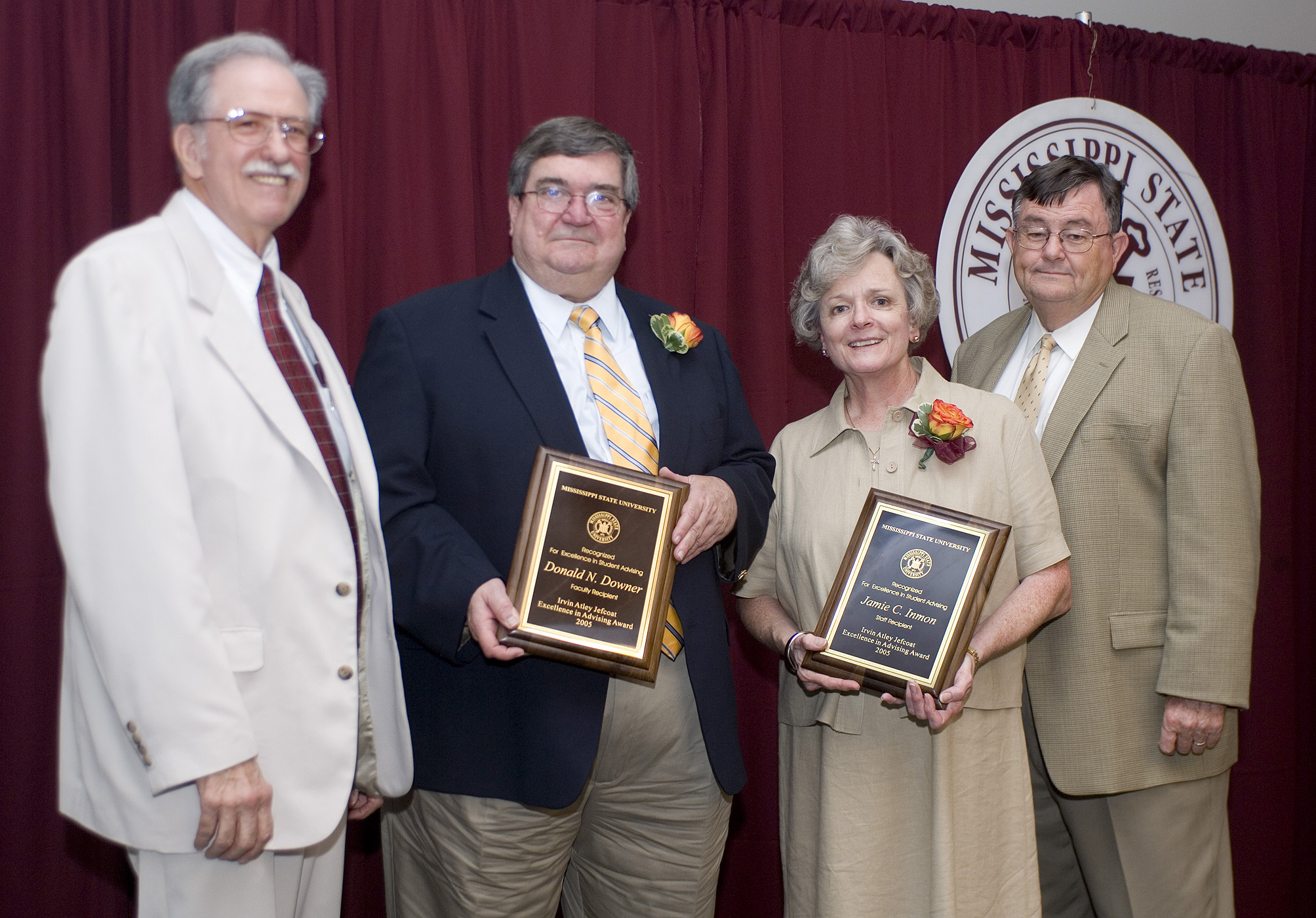 Student advisers Donald Downer (second from left) and Jamie Inmon receive congratulations from award namesake Atly Jefcoat (left) and MSU President Charles Lee. 