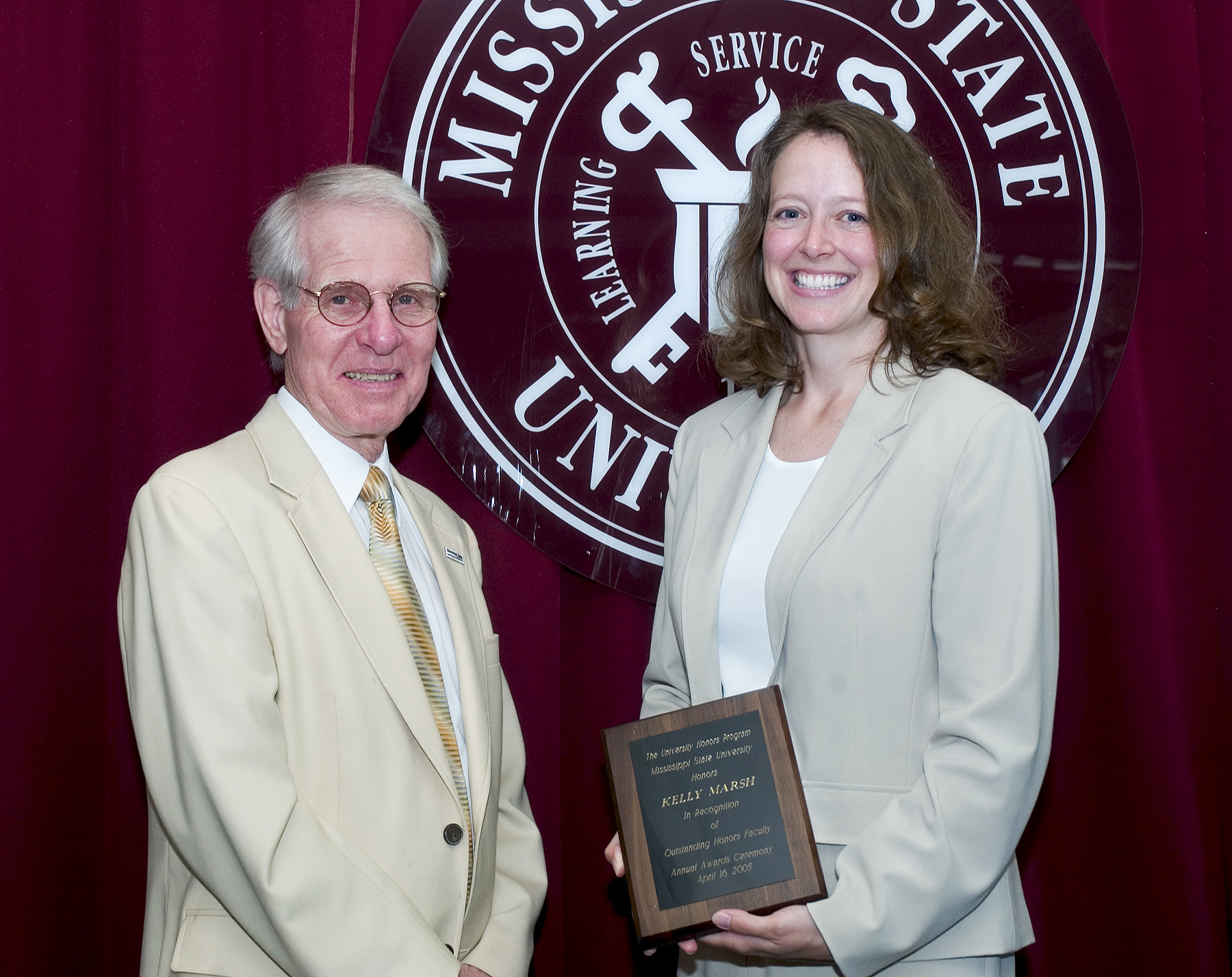 Provost Peter Rabideau presents the Outstanding Honors Faculty Award to English department faculty member Kelly Marsh.