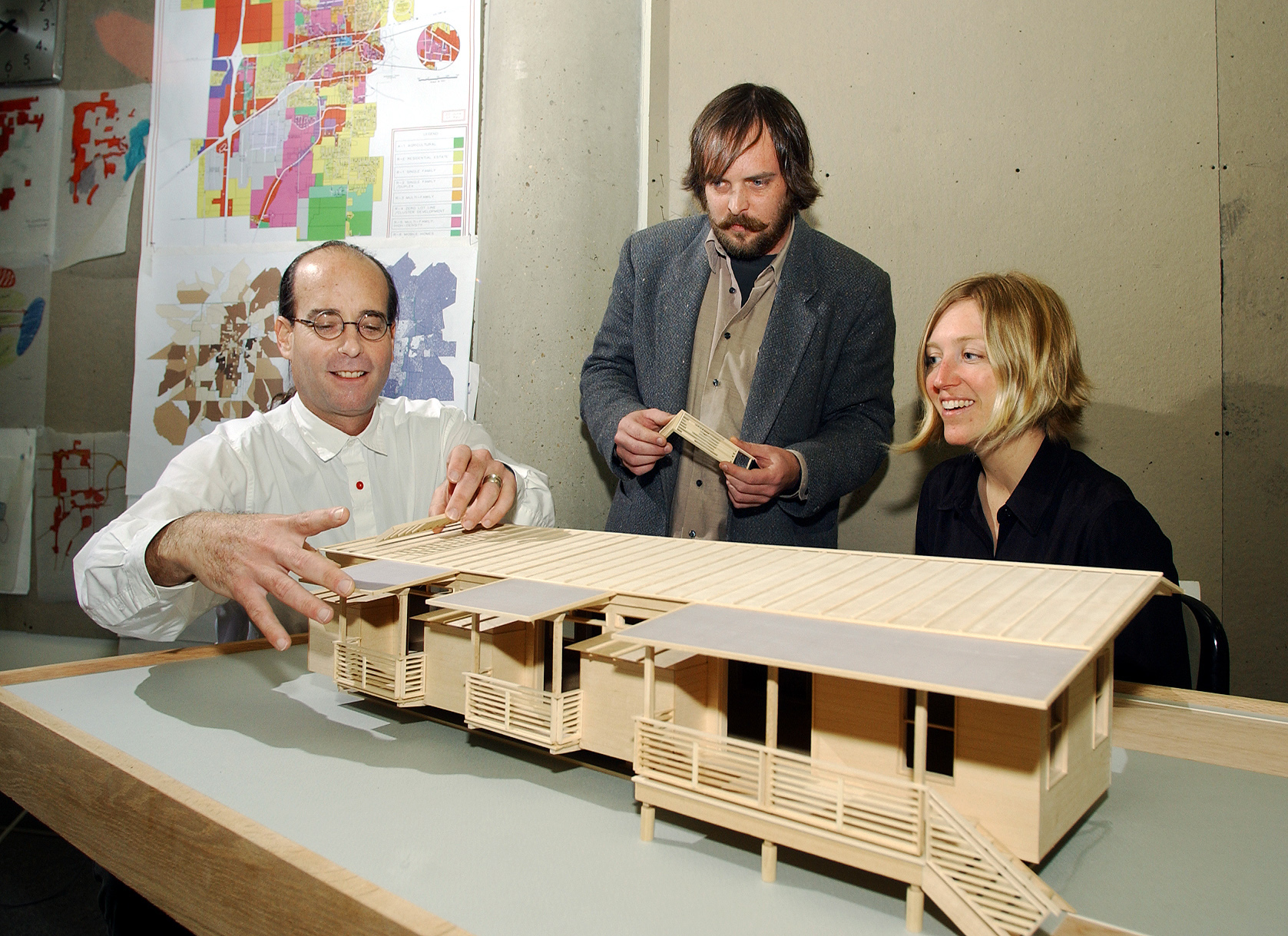 <br /><br />
Michael Berk (l) and Kimberly Brown of the Carl Small Town Center at Mississippi State look over an architectural model of the center's proposed sustainable mobile home.  Architecture intern Jason Pressgrove of Jackson (c) assisted with the project.  