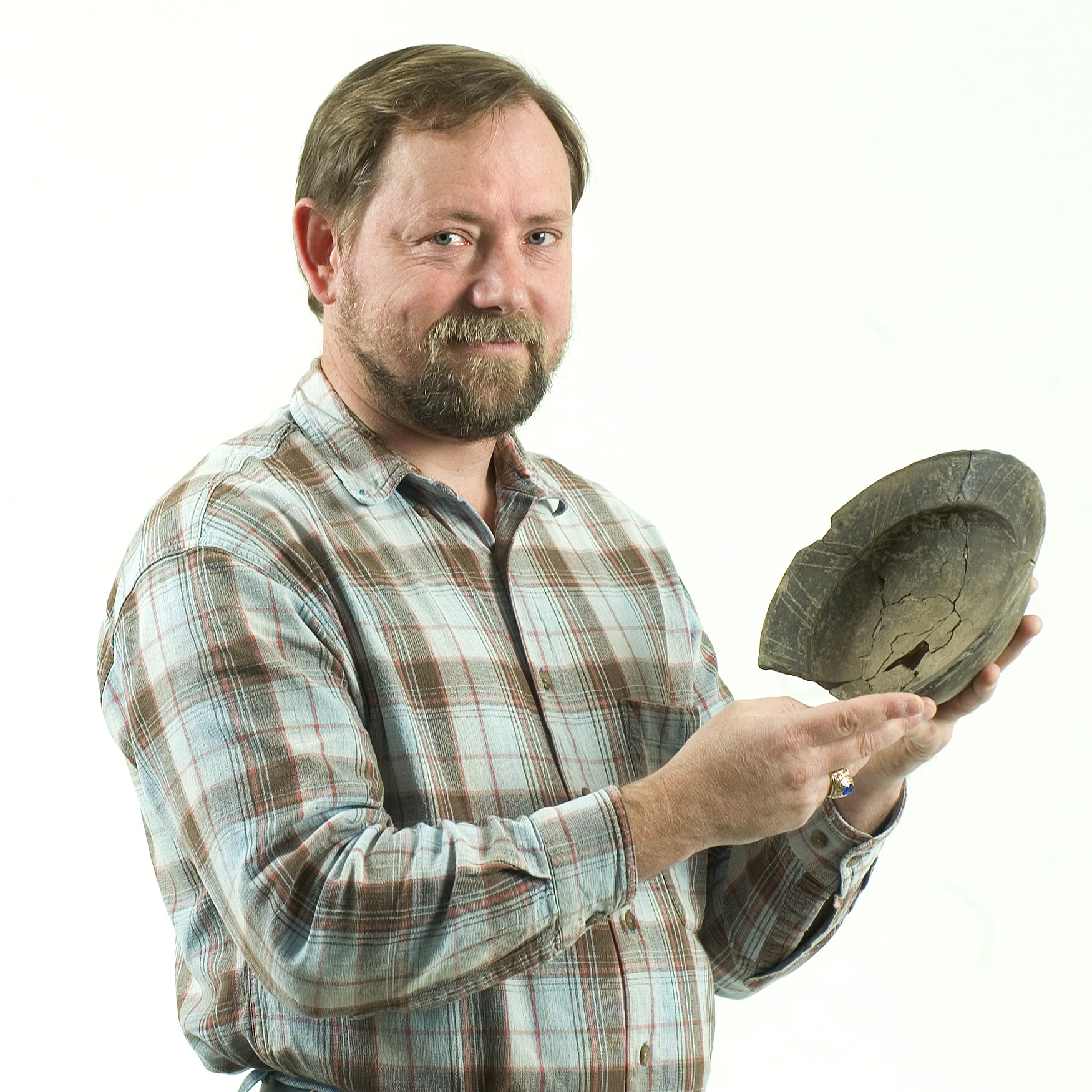 MSU associate professor of anthropology Evan Peacock displays a piece of Native American pottery, about 400-500 years old, that was unearthed from the Lyon's Bluff historic site near Starkville. The university's new "atomic paring knife" will enhance his archaeological research efforts.