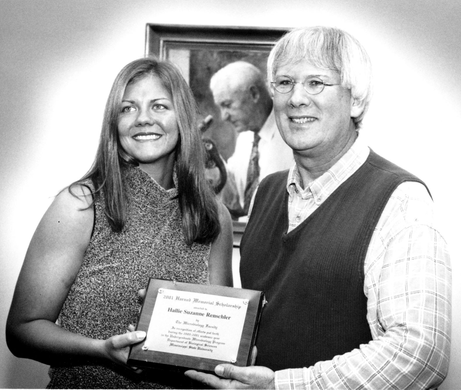 <br /><br />
Harned Scholar Hallie Renschler is congratulated by adviser Frank Champlin. 