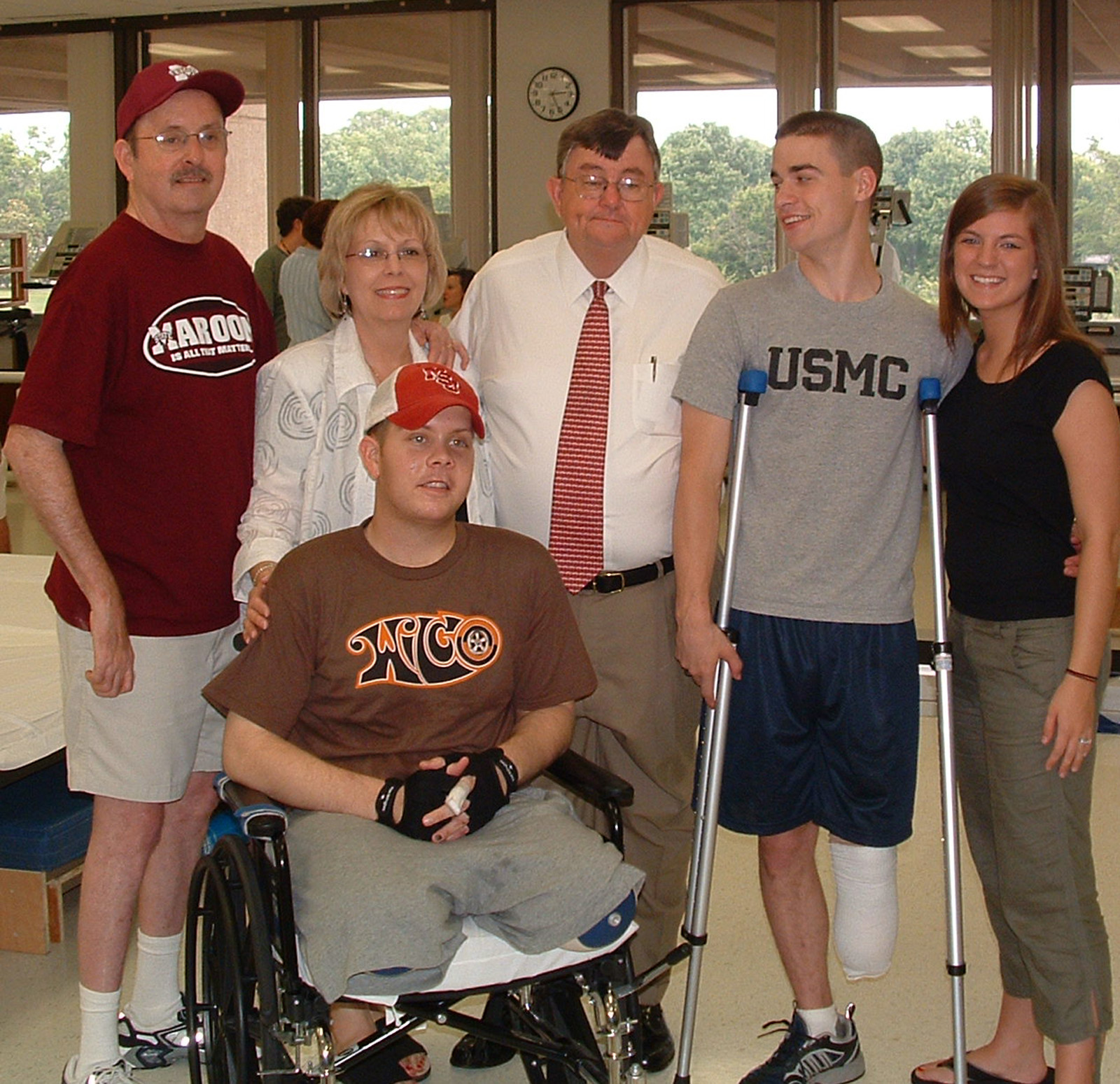 Mississippi Army National Guardsman William Brooks of Southaven (in wheelchair) and Marine reservist Aaron Rice of Sumrall (on crutches) are joined at the Walter Reed Army Medical Center in Washington, D.C., by (l-r) William's parents, Larry and Carolyn Brooks; Mississippi State University President Charles Lee; and Aaron's wife, Kelly. Marine reservist T.C. Rollins of Columbus (not pictured) was undergoing treatment at the National Naval Medical Center in Bethesda, Md. 