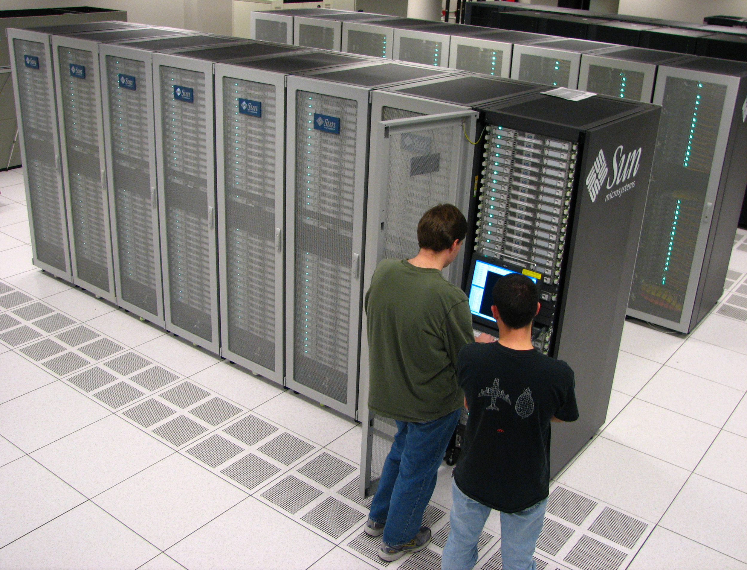 Mississippi State system administrators inspect the new Raptor supercomputer in the university's High Performance Computing Collaboratory.