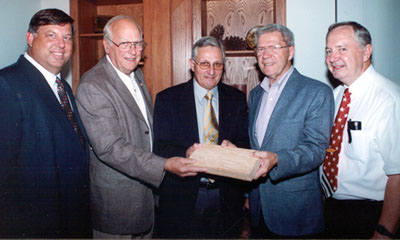 <br /><br />
Forest Products professors Dan Seale (l) and Terry Sellers (r) look over a board with TimTek directors (l to r) Walter Jarck, Geoff Sanderson and Dave Mortensen. 