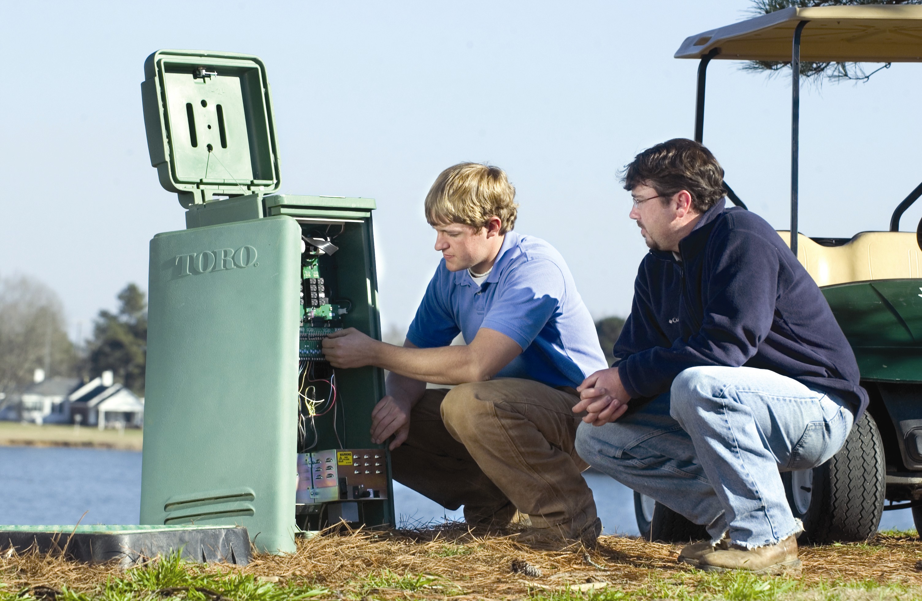 MSU sports and turf management majors Jordan Carlisle (l) and Keith Julkenbeck examine Toro sprinkler controls.